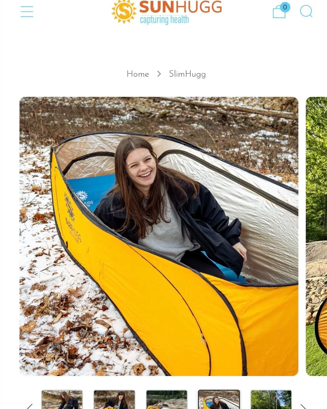 A woman smiling inside a yellow camping tent outdoors on a snowy ground with fallen leaves.