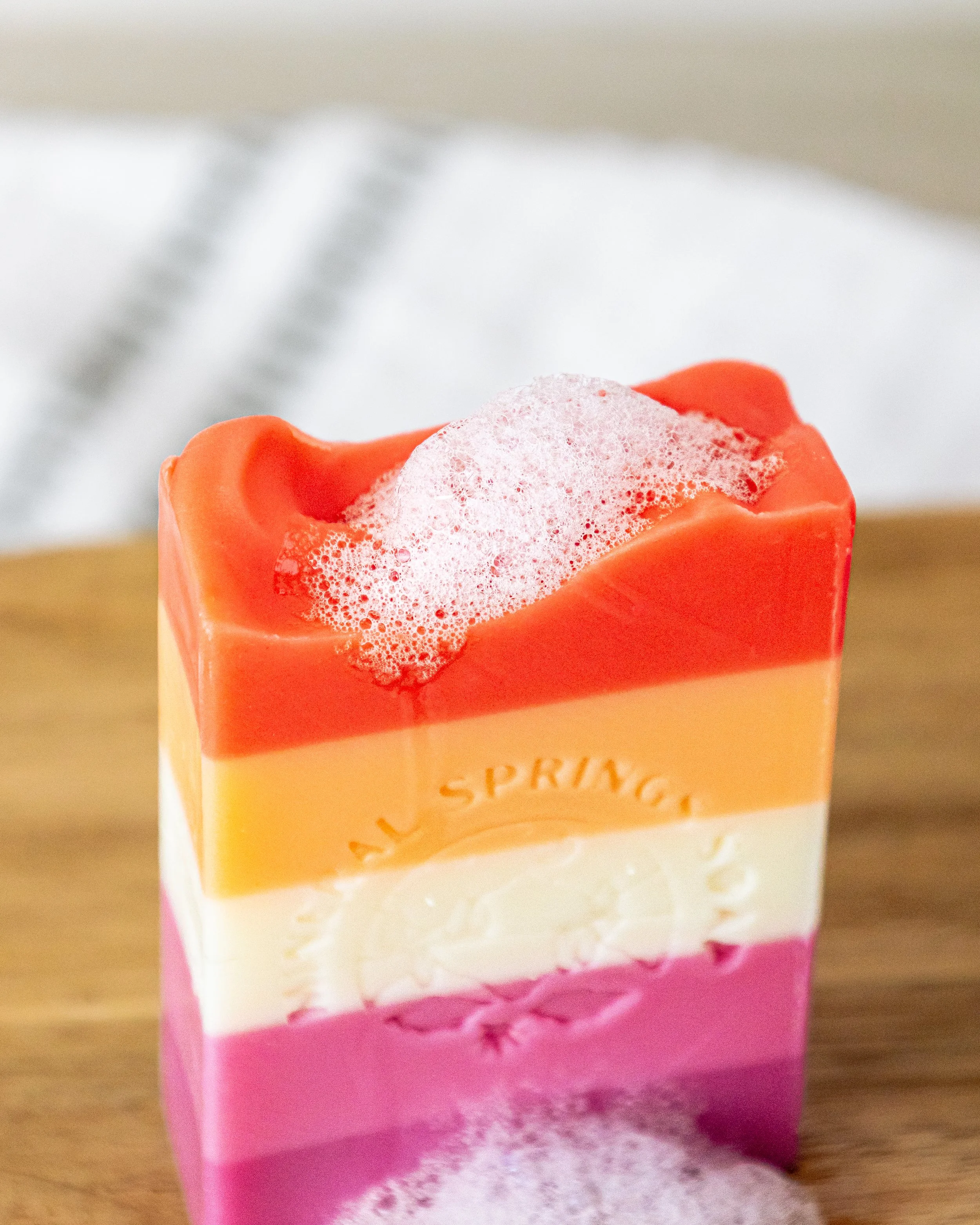 Product photography of handcrafted Mineral Springs Soaps highlighting layered colors, texture, and detail in clean, natural styling.