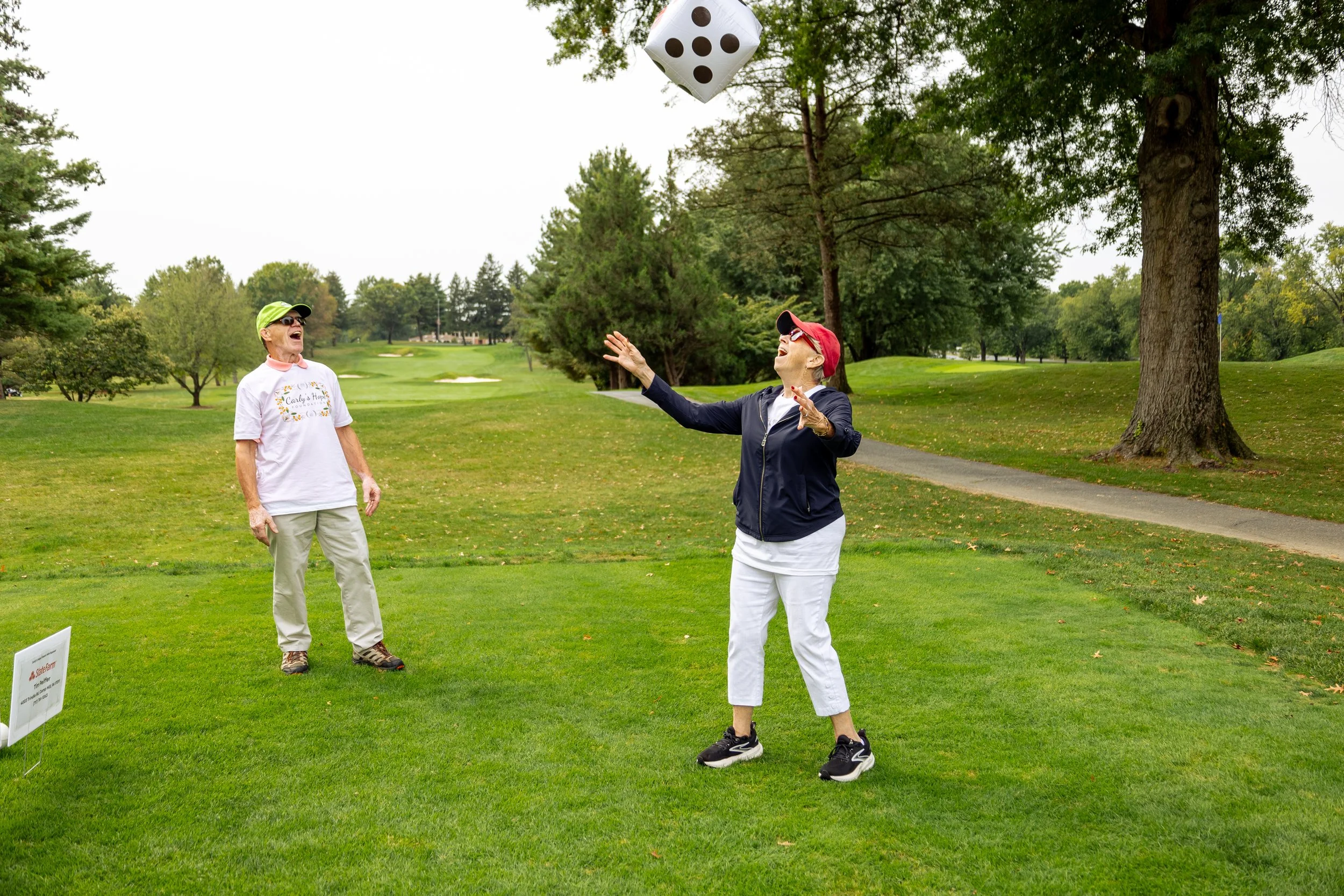Event photography from a nonprofit golf outing, documenting golfers, course details, group moments, and candid interactions throughout the day in a natural, documentary style.