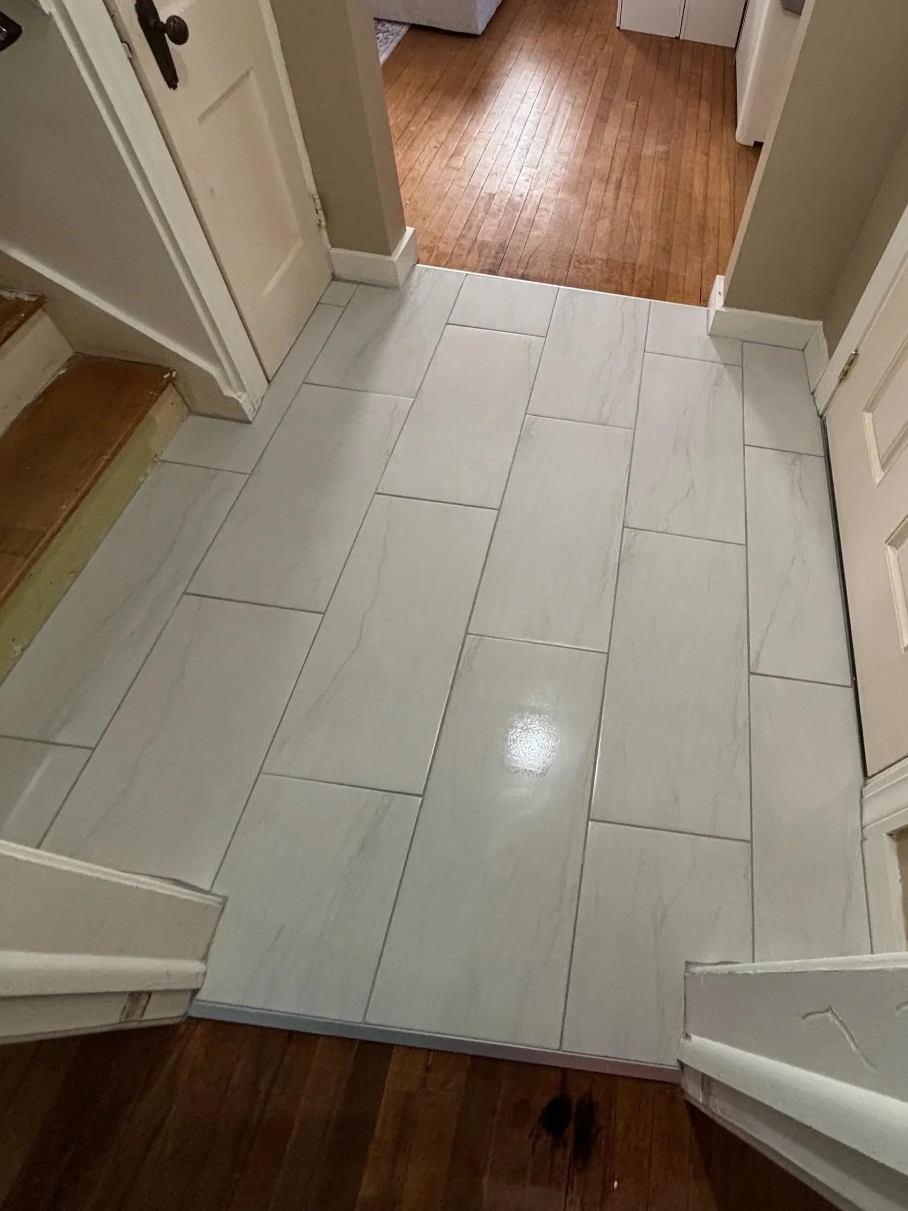 Large format porcelain tile flooring installation with a marble-look finish completed by JK Flooring & Tile.
