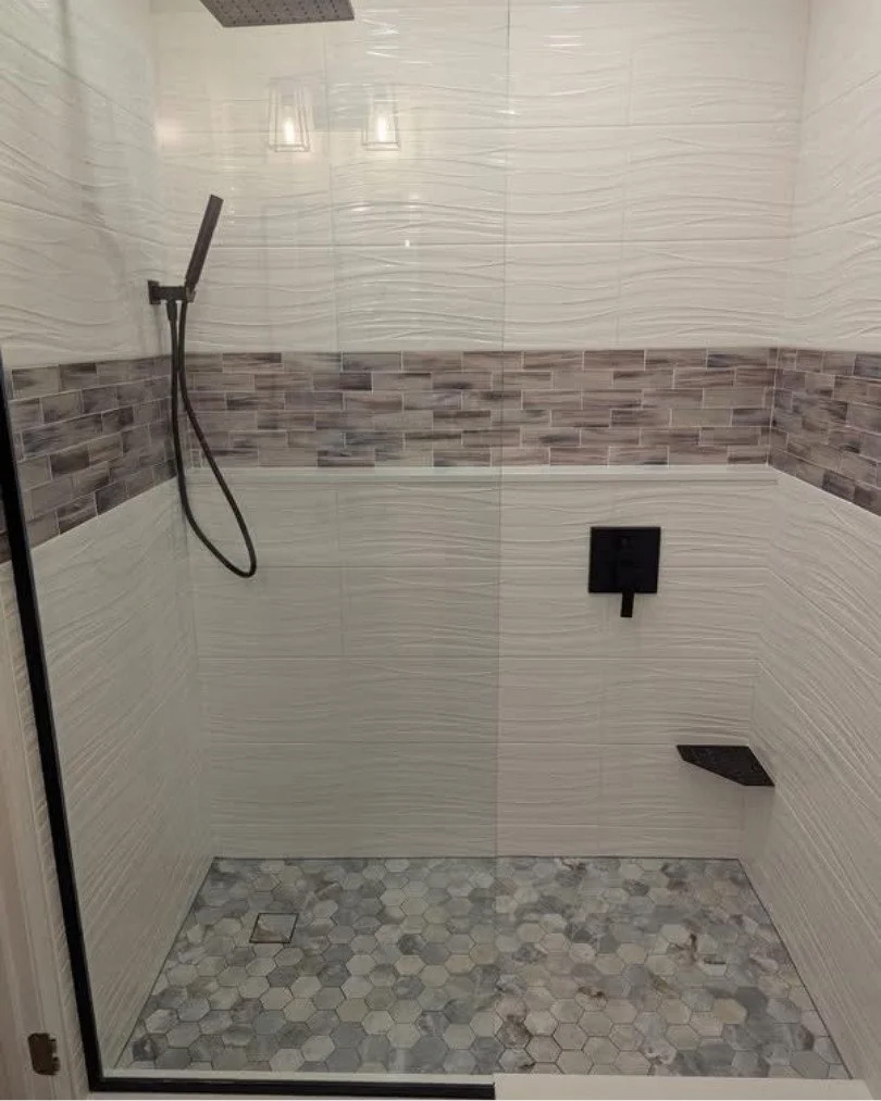 Porcelain tile shower installation featuring large-format tile, glass shower enclosure, and durable waterproof bathroom flooring.