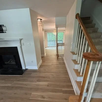 Luxury vinyl plank flooring installation with staircase renovation in a residential home by JK Flooring & Tile.