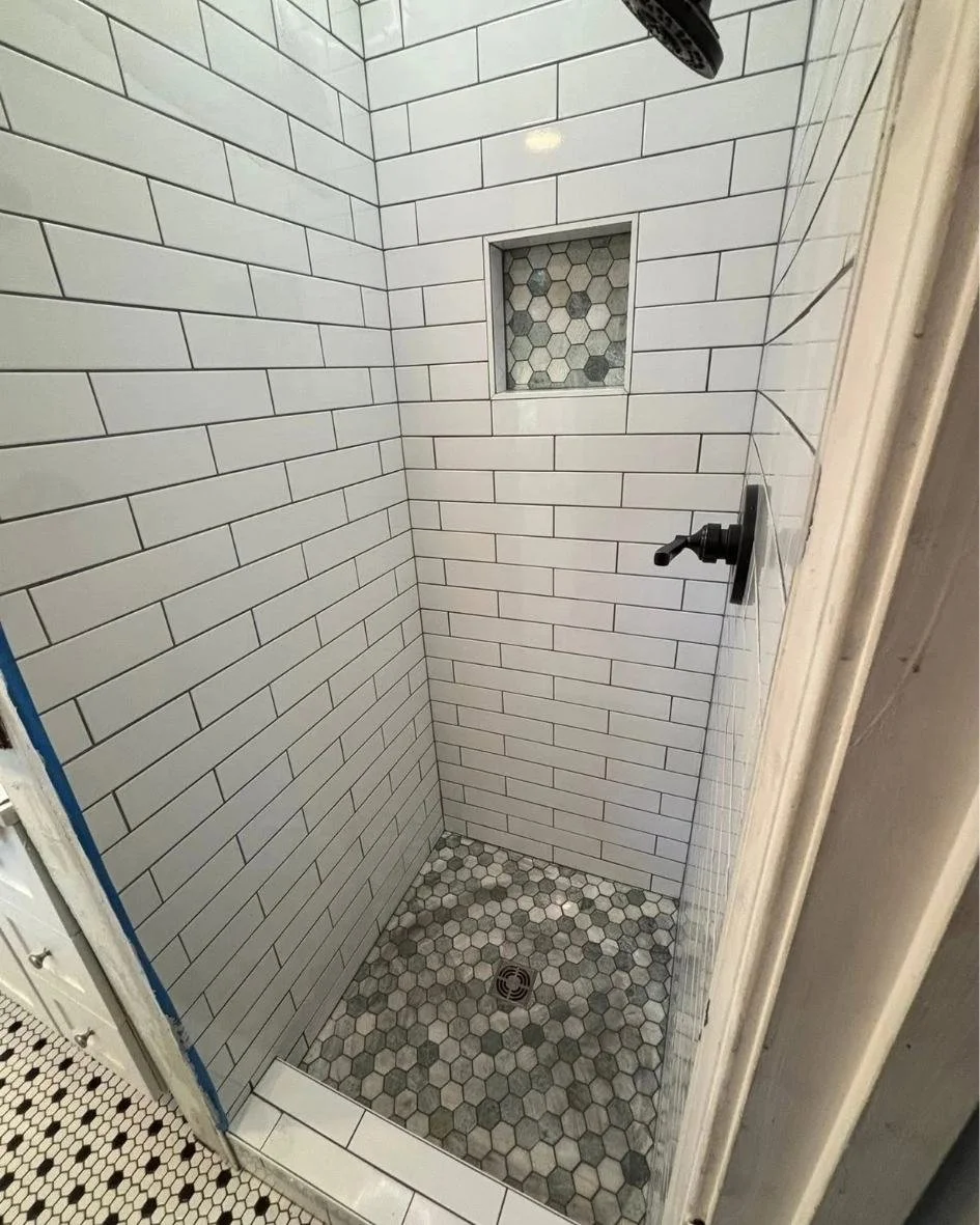 Completed flooring installation with detailed trim and finishing work by JK Flooring & Tile.
