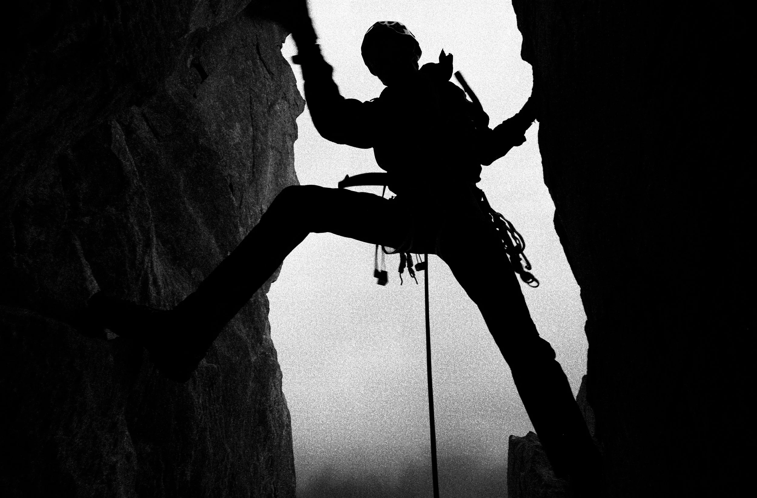 Black and white silhouette of a climber in Snowdonia/ Eryri national park.