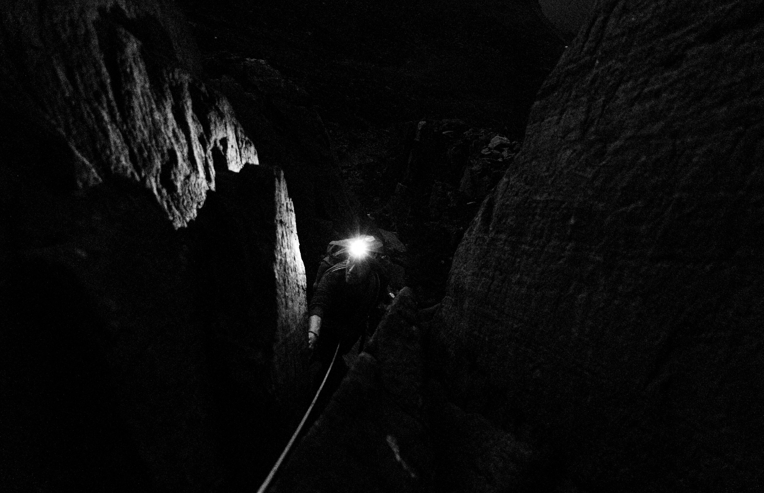 Night time climbing in Eryri on Tryfan, rock and climber illuminated by headtorch