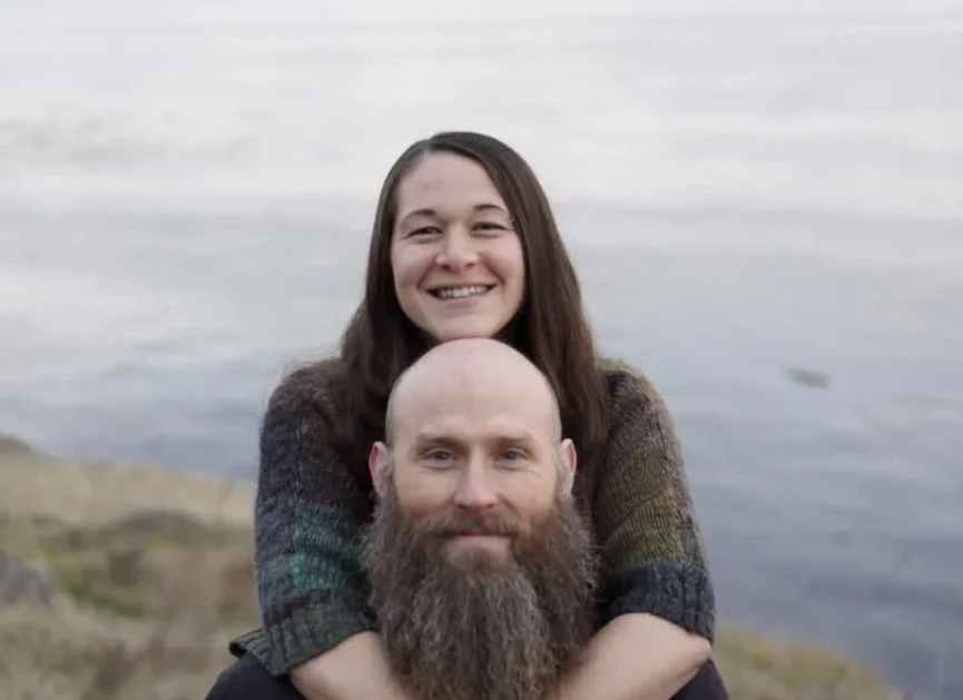 Man and woman smiling near a body of water