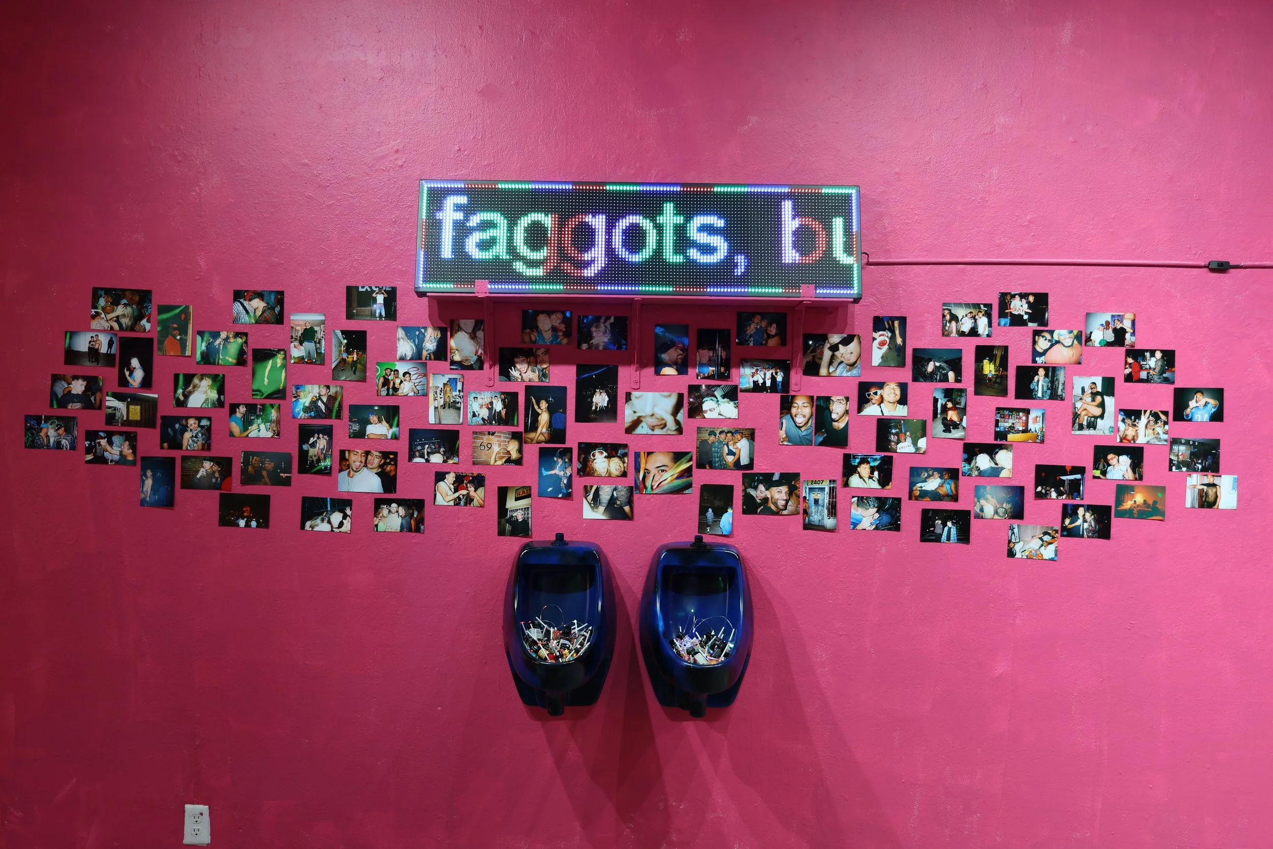 Cruising Utopia (We're Saving Nightlife!) (2026) Installation View (Lights On) 
Spray Paint, Urinal, Popper Bottles, Chupa Chups Lollipops, String Lights, LED Sign, Archival Inkjet Prints Size Variable