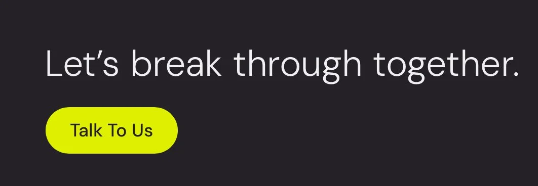A black background with white text saying "Let's break through together." and a yellow button with black text saying "Talk To Us."