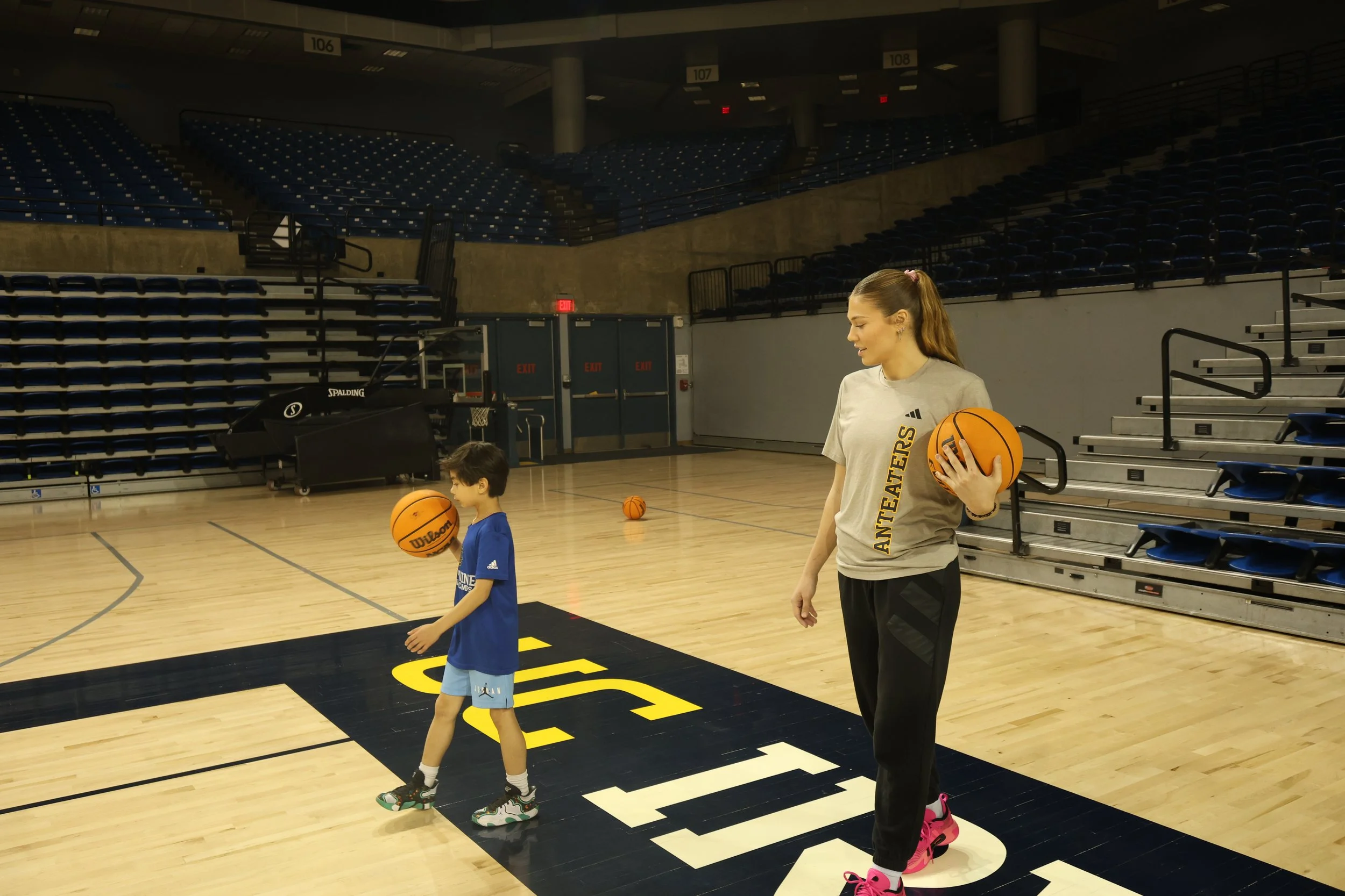 Private basketball training session with an NCAA Division 1 athlete, helping a young player improve skills on the court.
