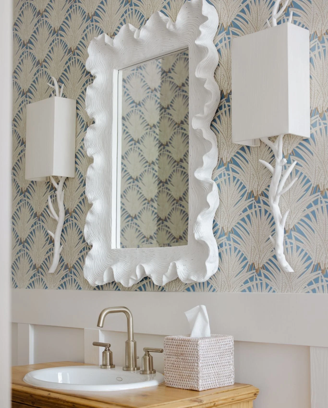 🌿Powder Room Personality 🌿⁠
This space proves that small rooms can make a big statement. A sculptural mirror, whimsical sconces, and palm-inspired wallpaper create a layered look that&rsquo;s both playful and refined. Paired with a warm wood vanity