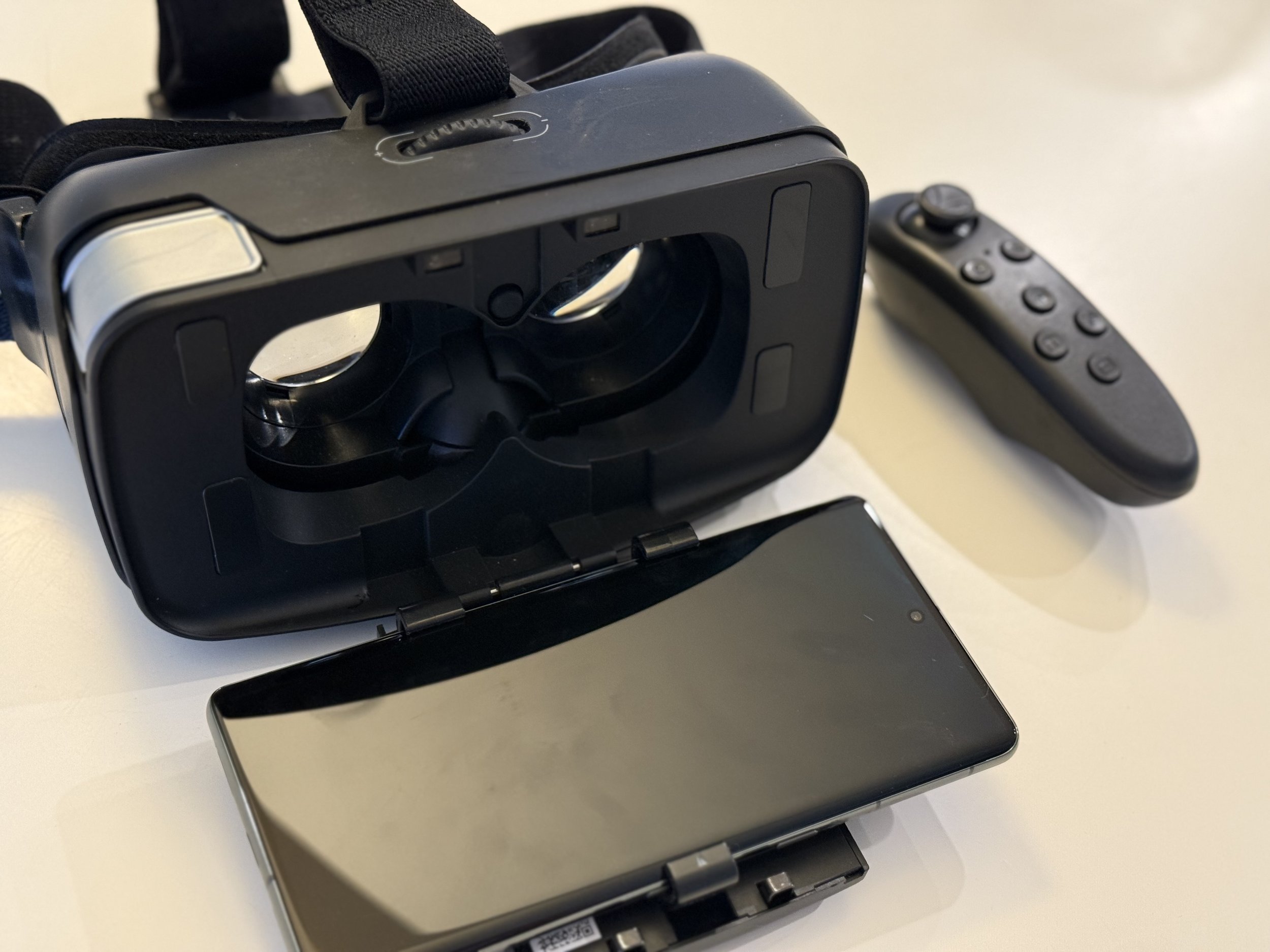 Open headset displaying phone screen and remote control