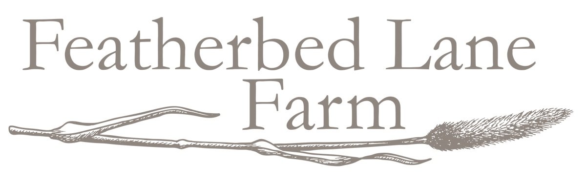 Logo for Featherbed Lane Farm with stylized branch and feather graphic.
