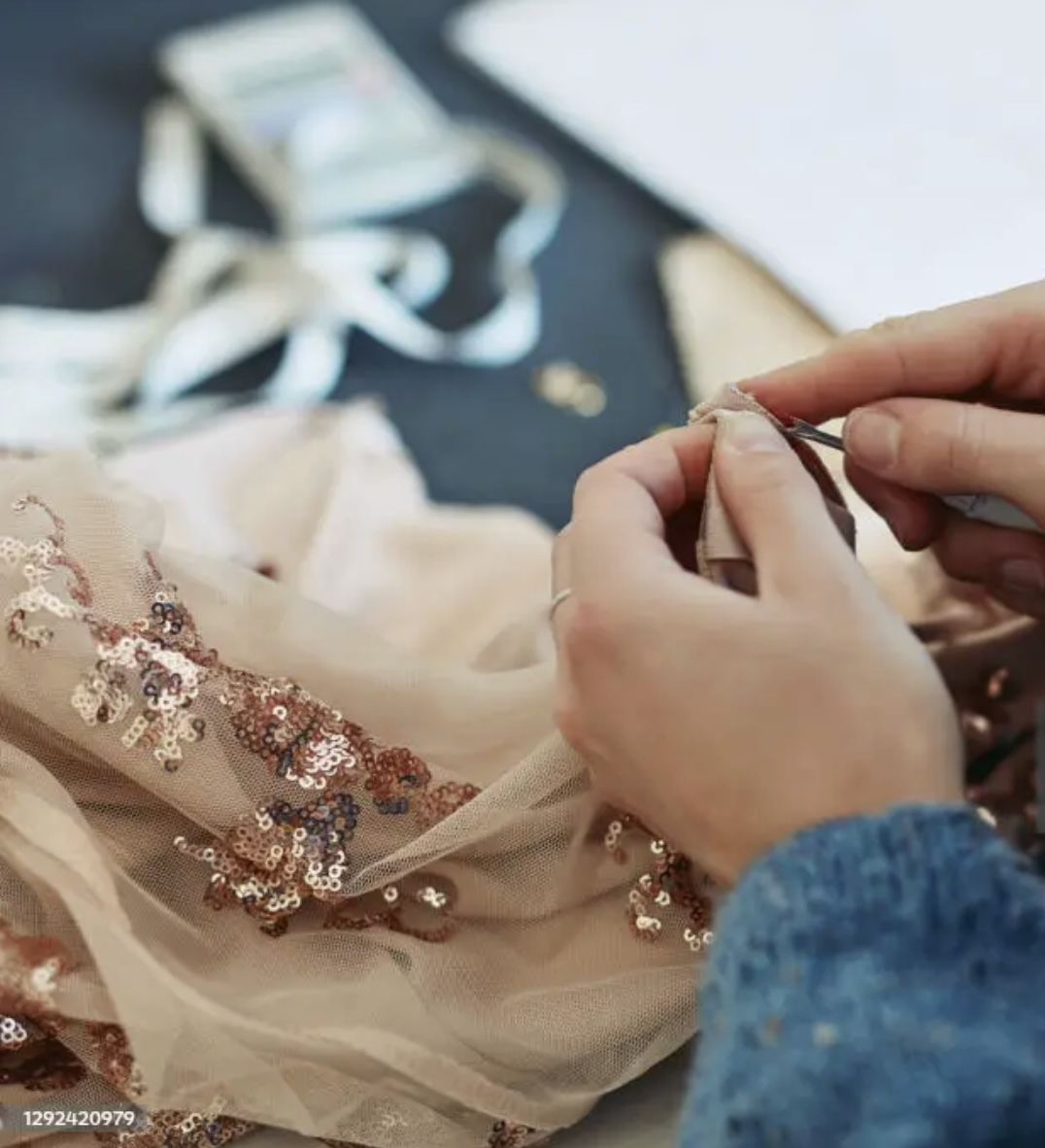 Seamstress altering a formal gown