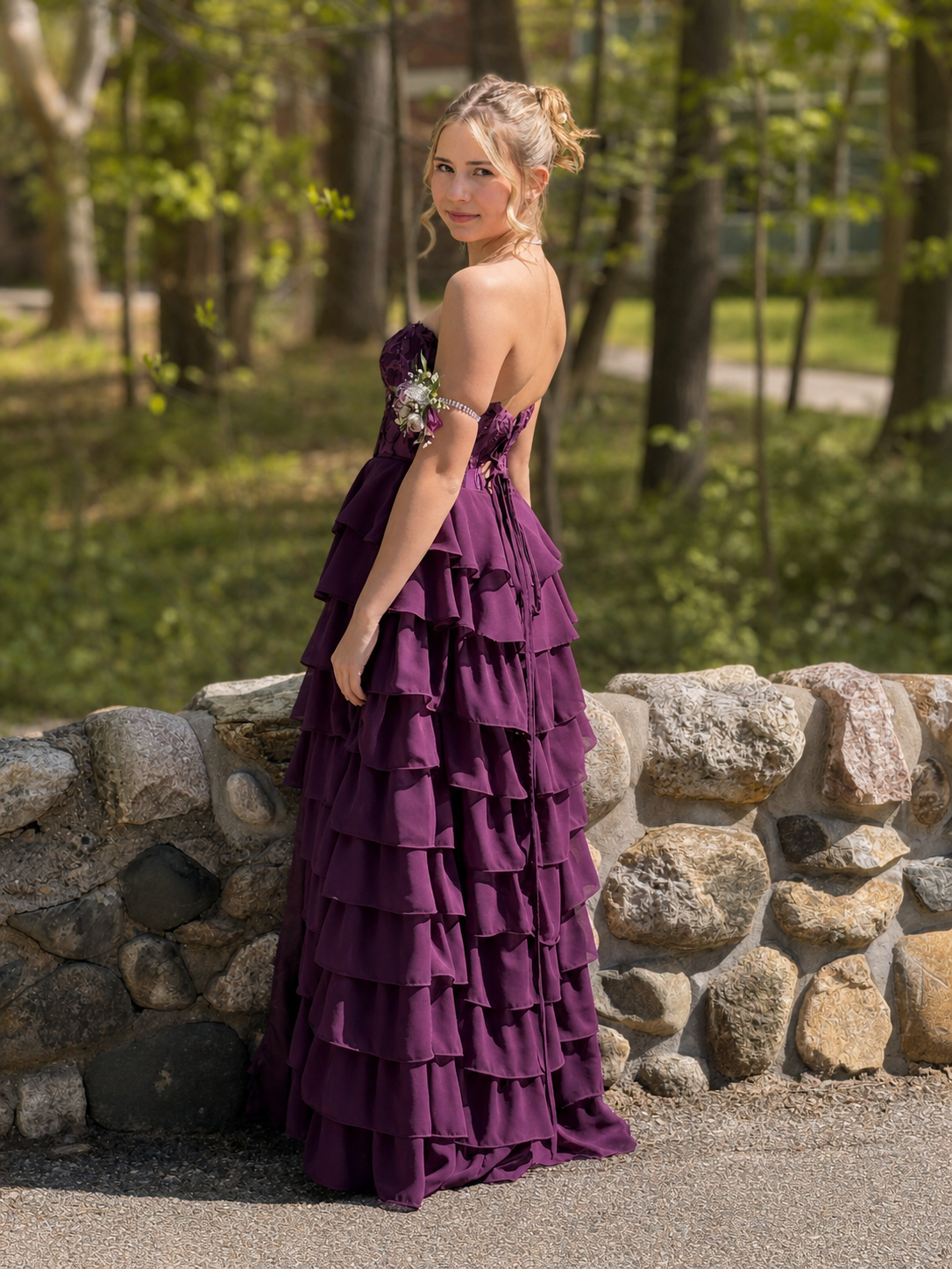 Young woman modeling a fitted purple tiered prom gown after special occasion alterations near Grand Rapids, Michigan.