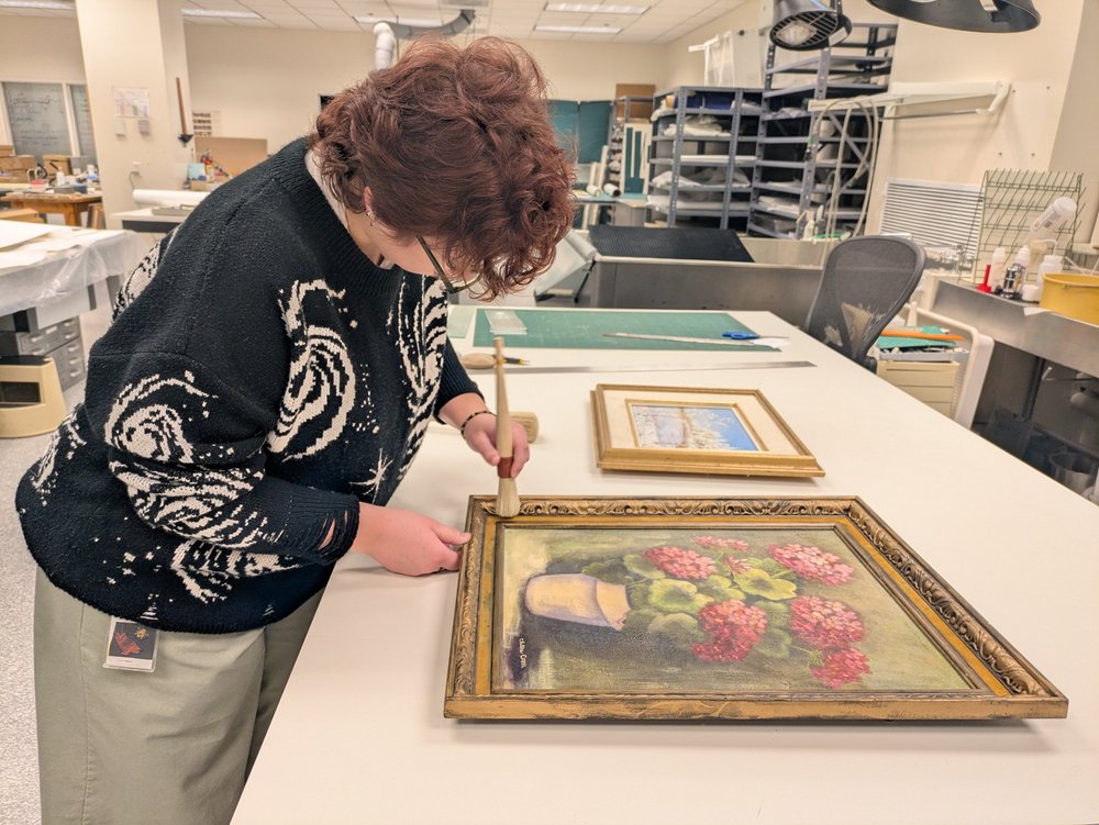 Surface cleaning a frame to prepare it for hanging.