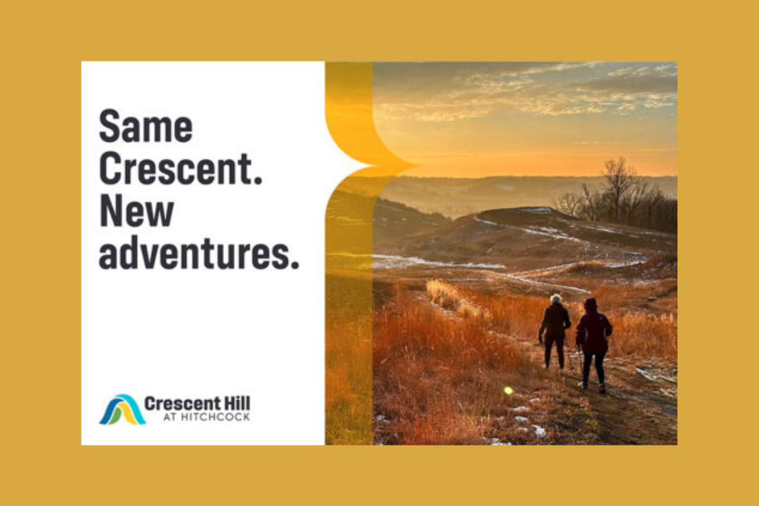 An ad featuring photography of the Loess Hills reads, "Same Crescent. New adventures."