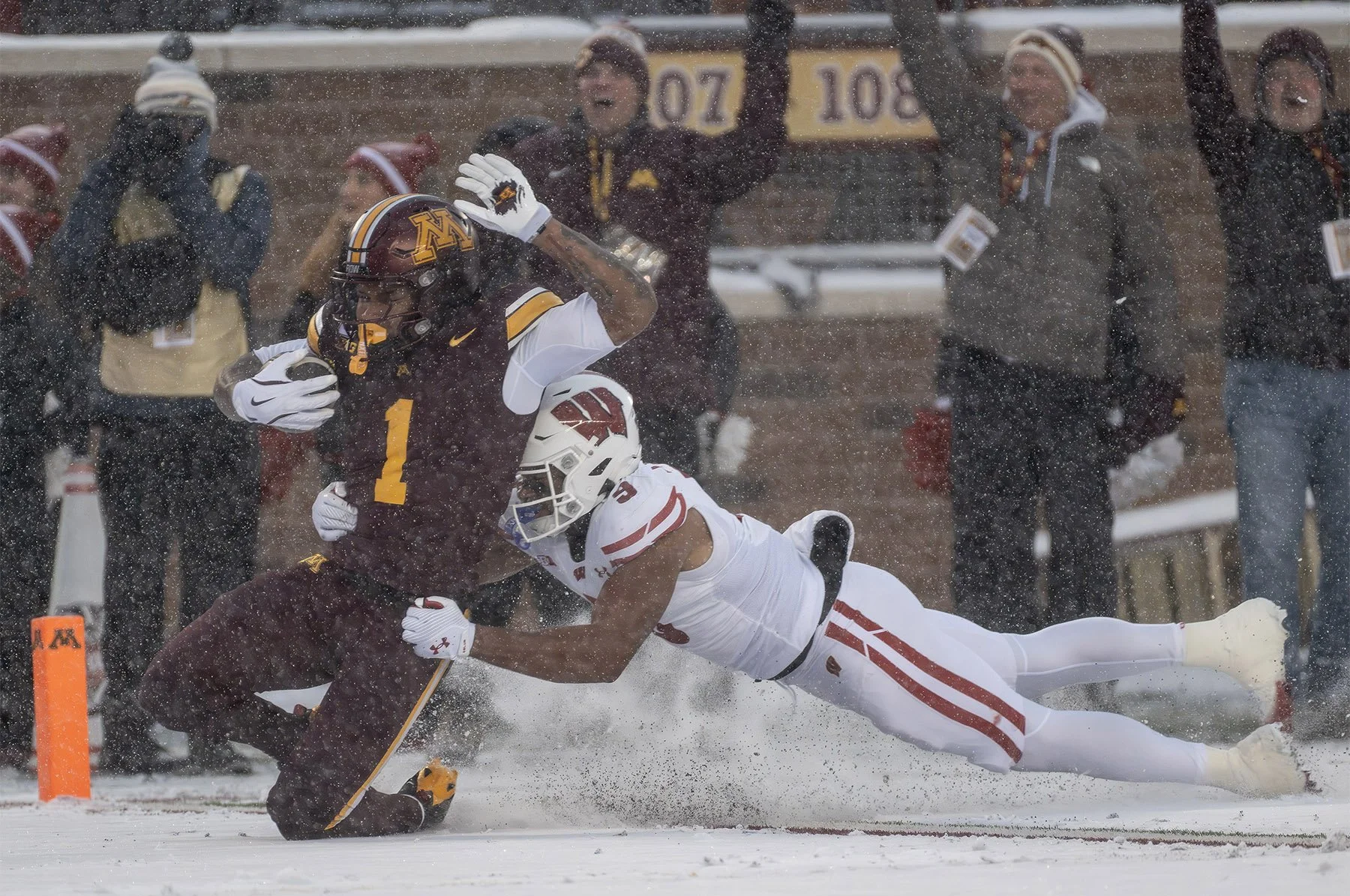 Minnesota running back Darius Taylor (1) scores a touchdown as he’s tackled by Wisconsin safety Austin Brown (9) during the first half of an NCAA college football game, Saturday, Nov. 29, 2025, in Minneapolis. 