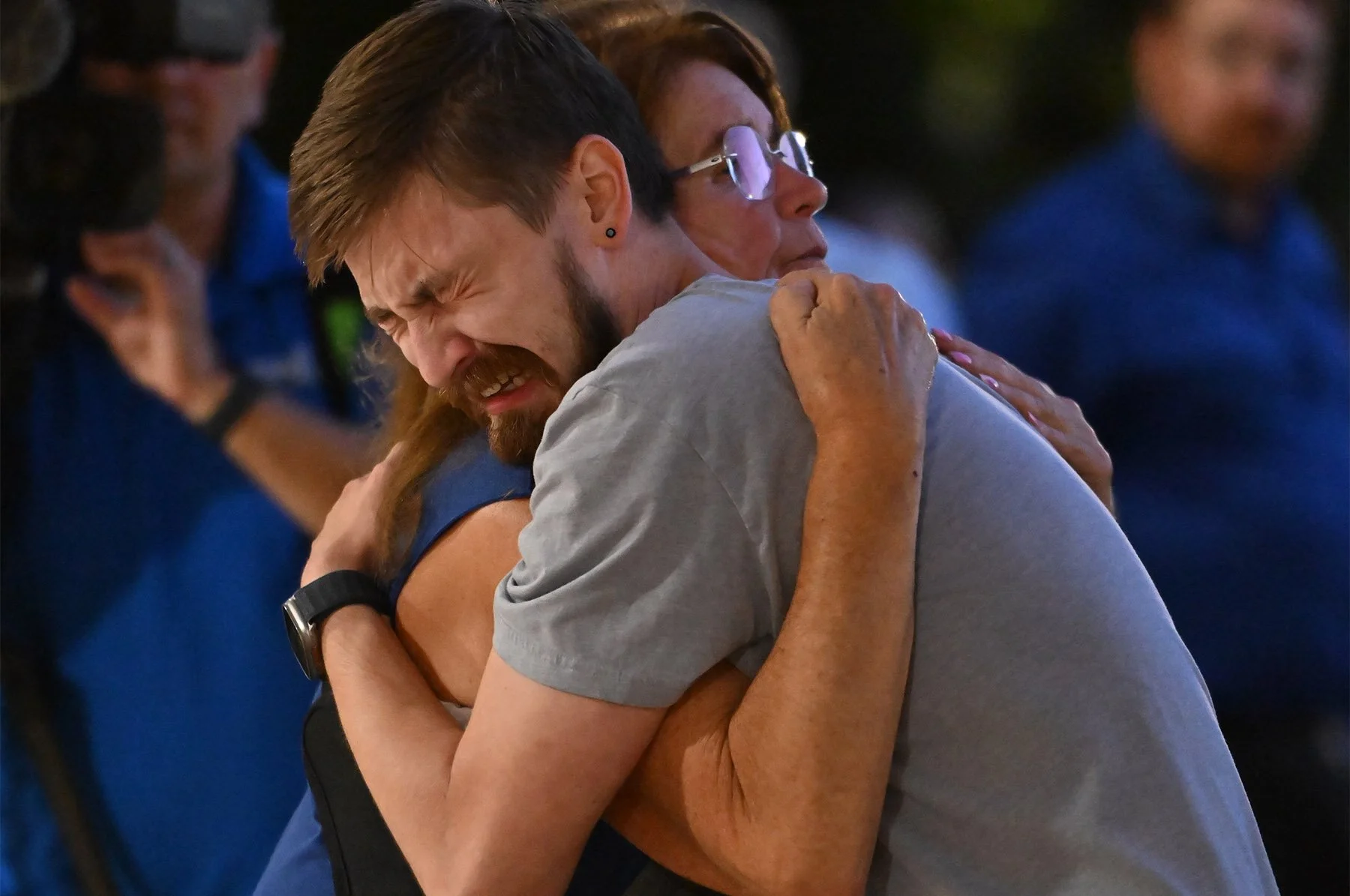Mourners embrace during a vigil at Academy of Holy Angels in Richfield, Minn., for the victims of a mass shooting at Annunciation School in Minneapolis, where three were killed, including the shooter, and dozens injured on Wednesday, August 27, 2025.