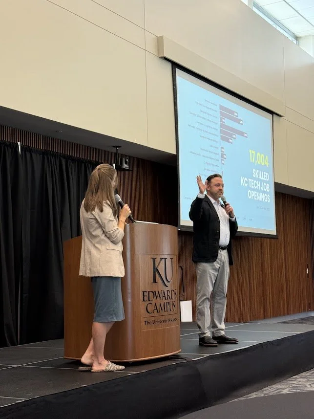 Two people presenting at a podium