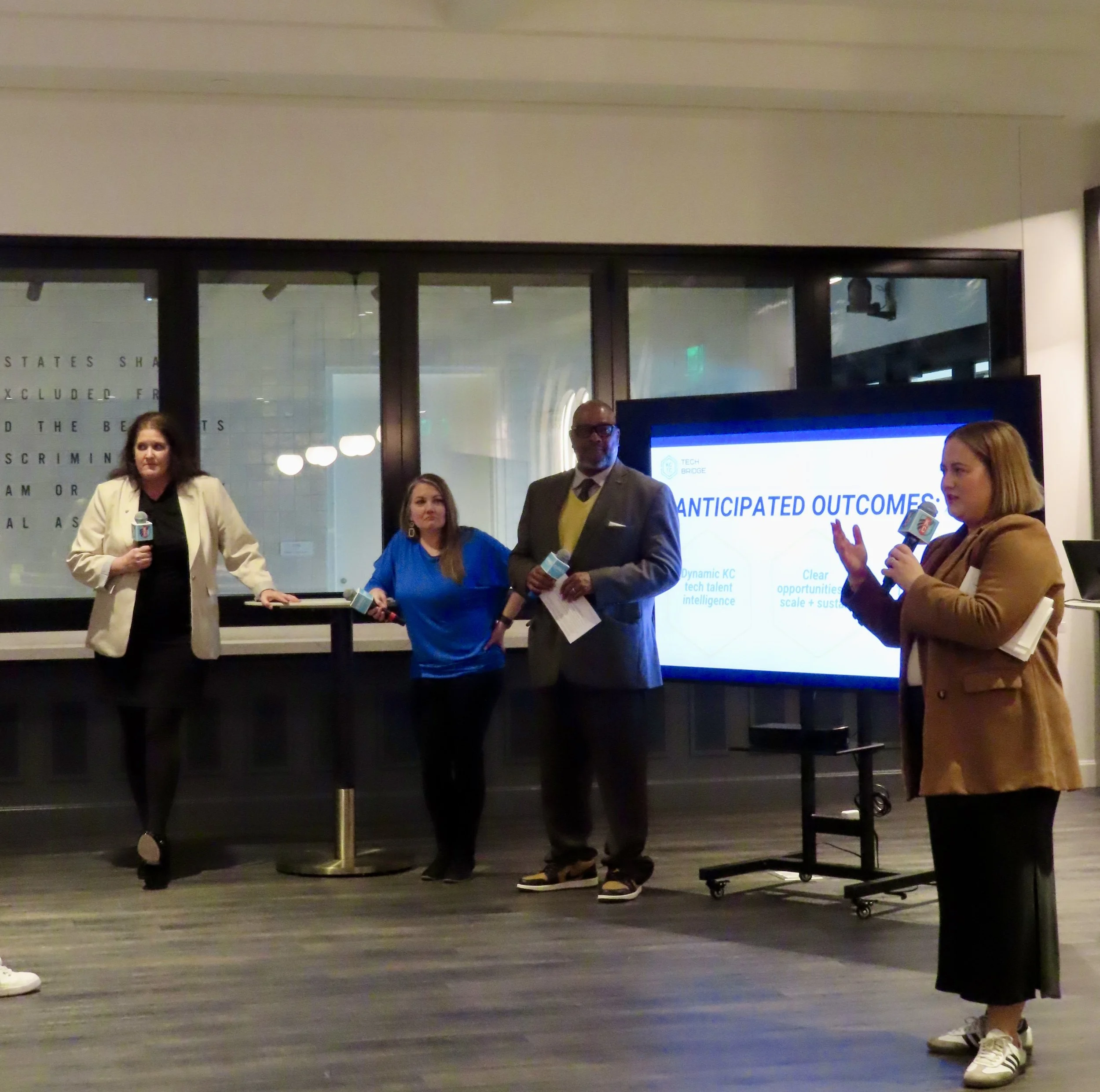 four people standing together