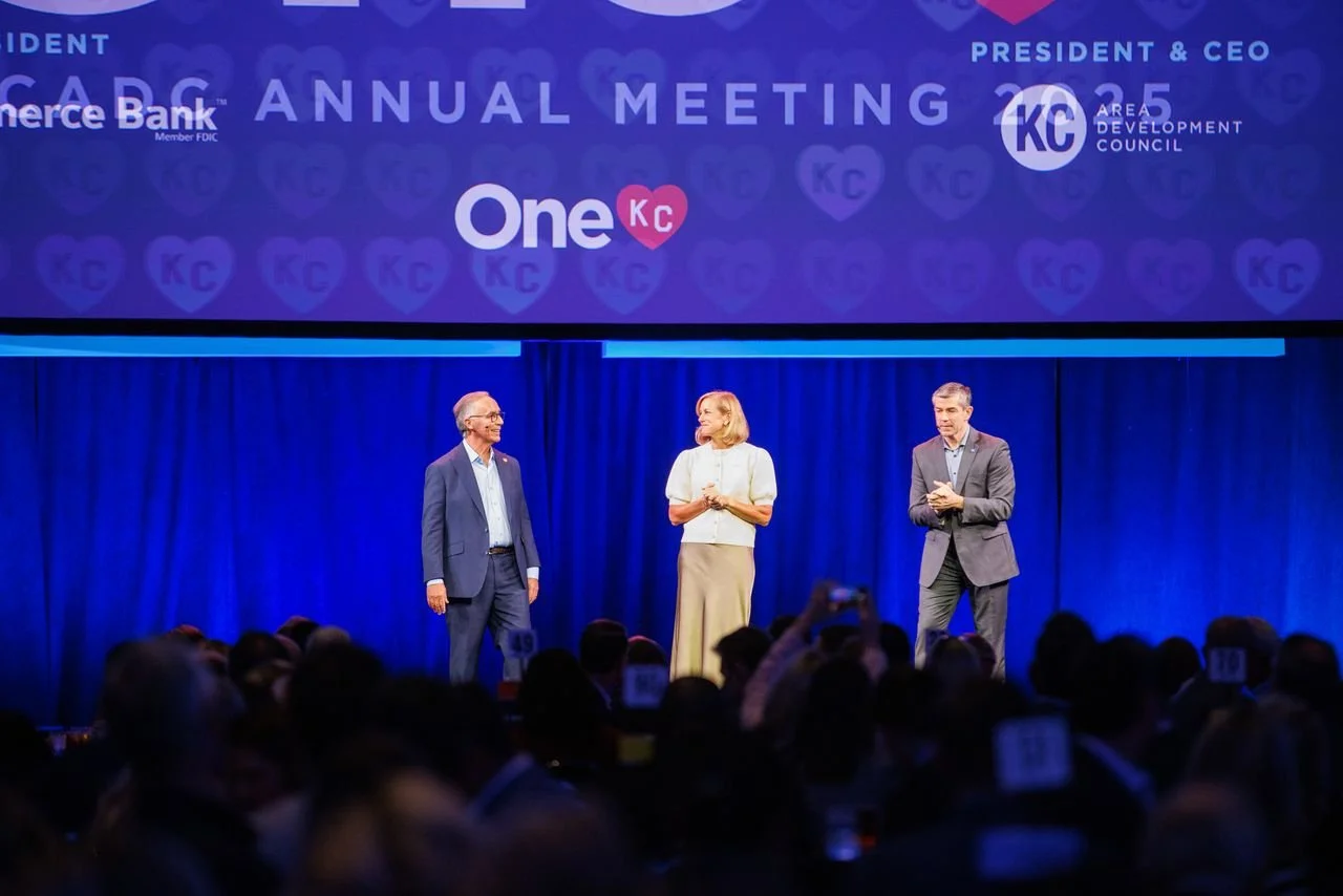 three people standing on a stage