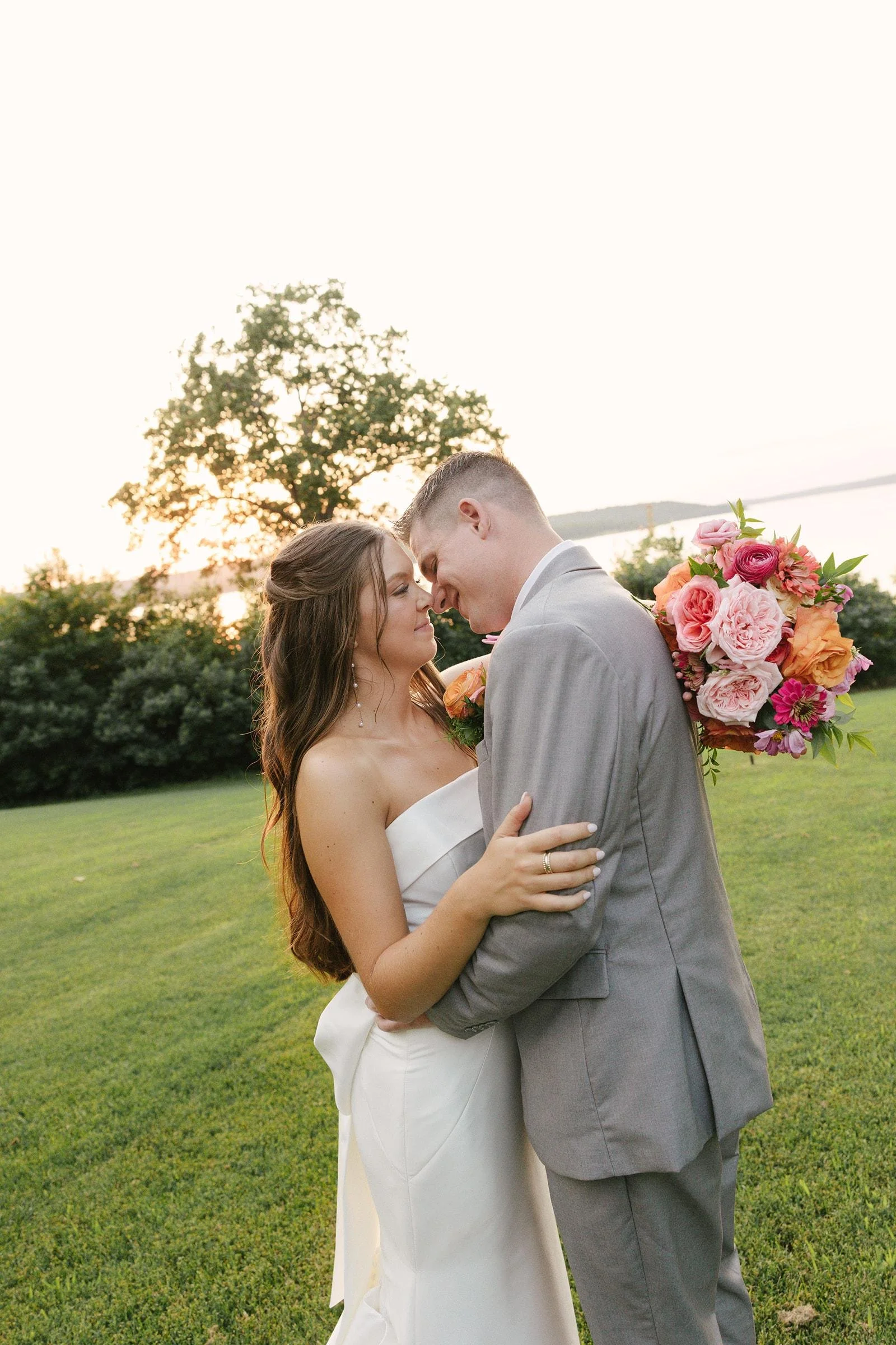 couple portrait spring bouquet and lake view