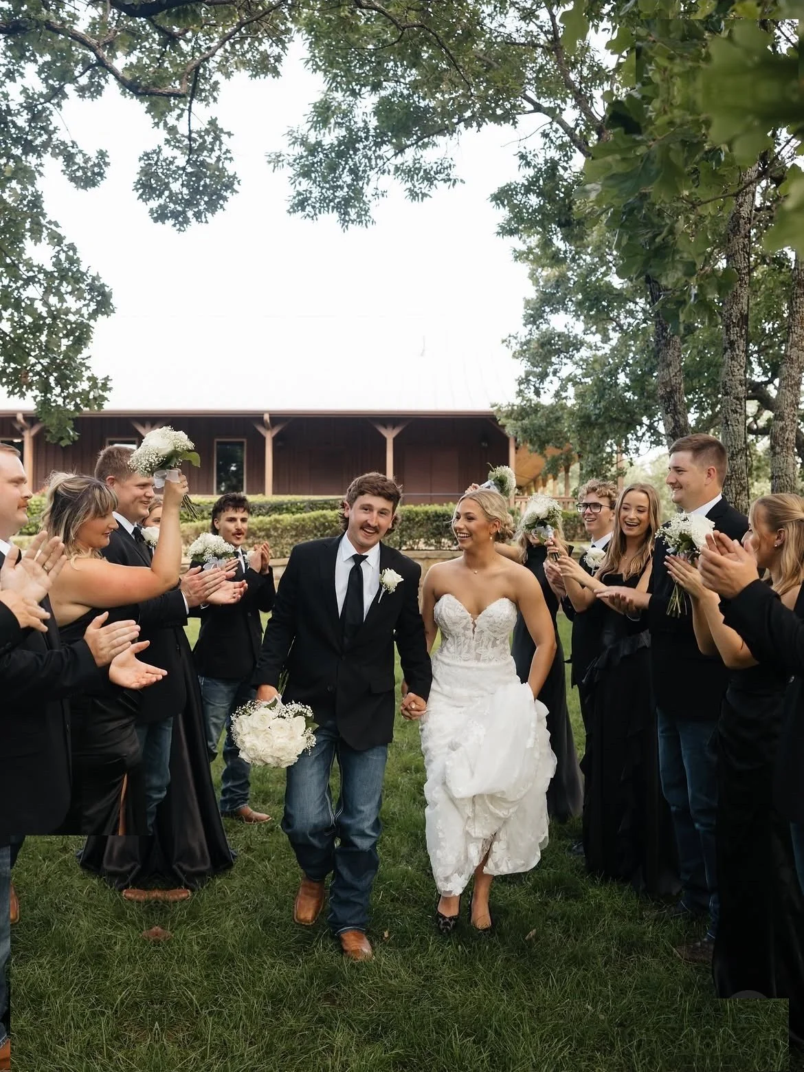 09-rayleigh-mason-the-springs-wedding-couple-walking-through-wedding-party.jpg