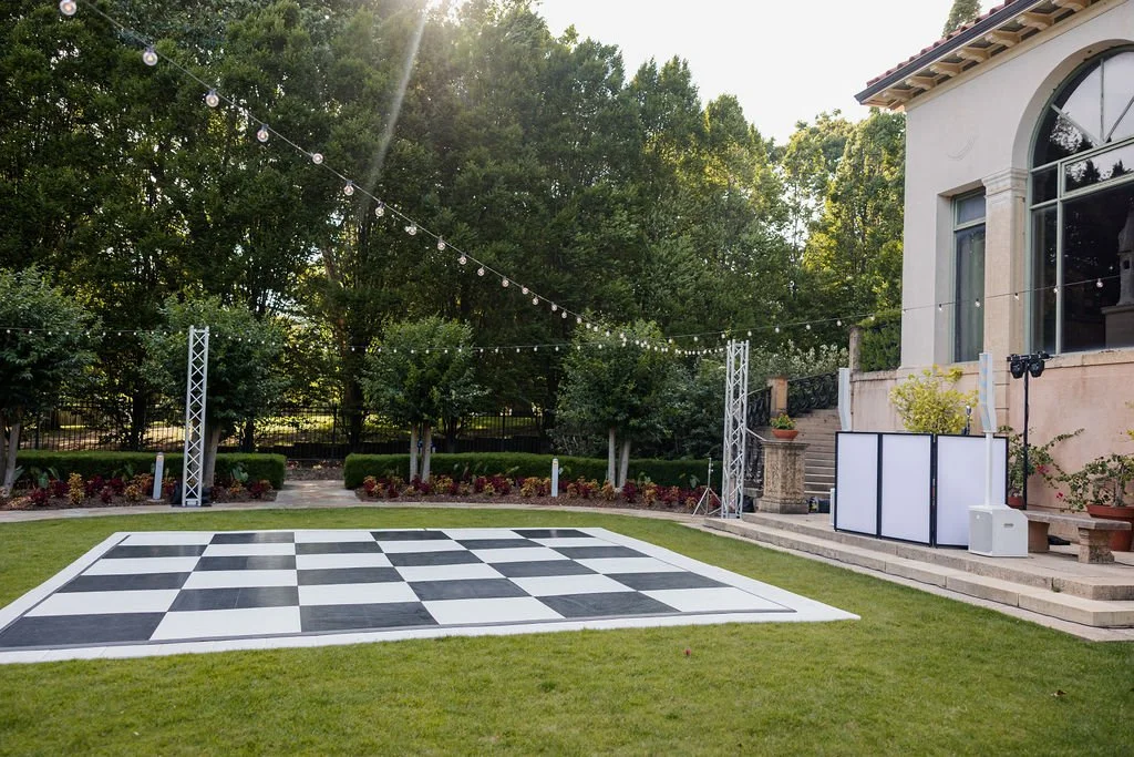 Black and white dance floor in front of dj booth
