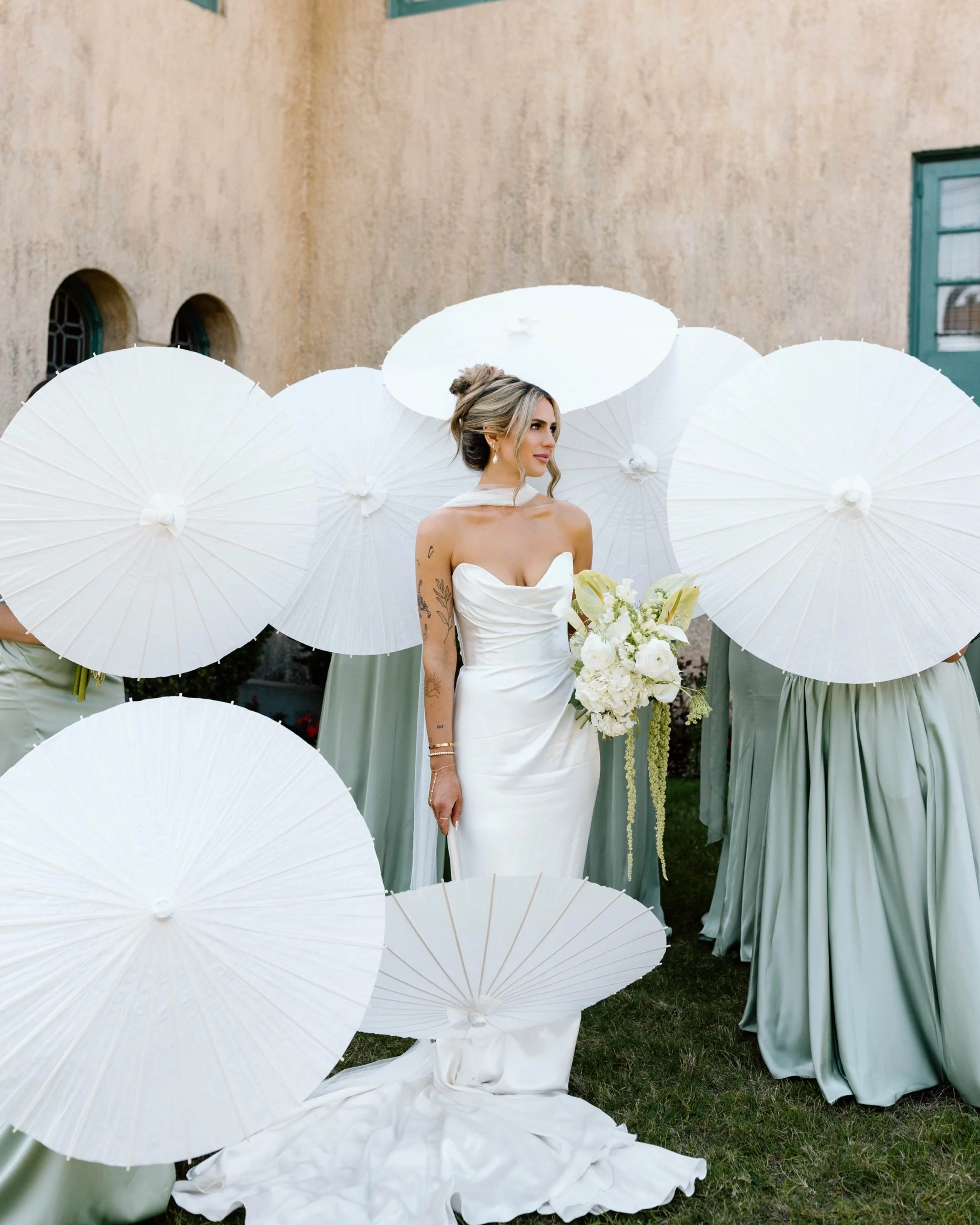 bride surrounded by parasols