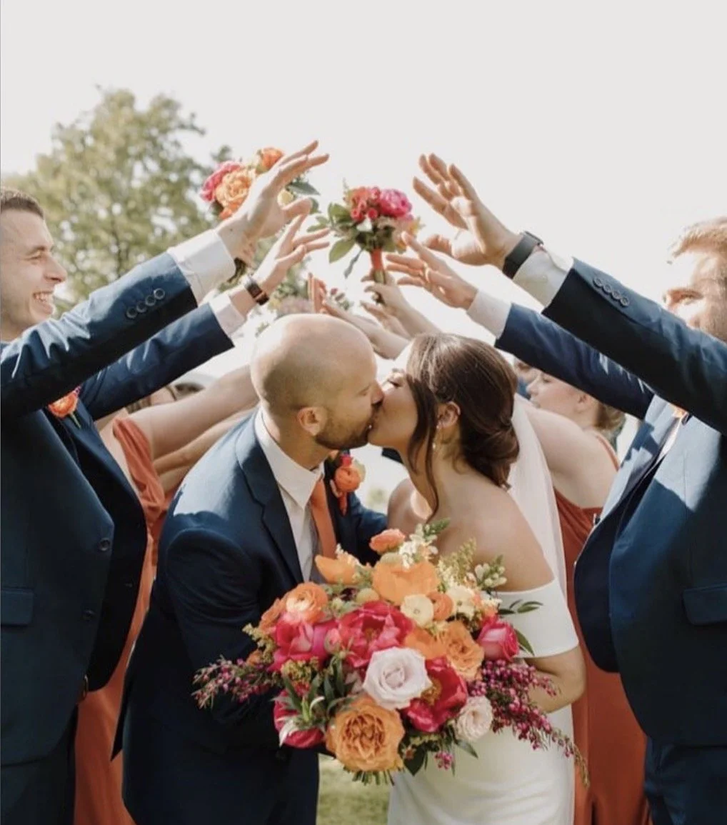 couple celebrating with wedding party