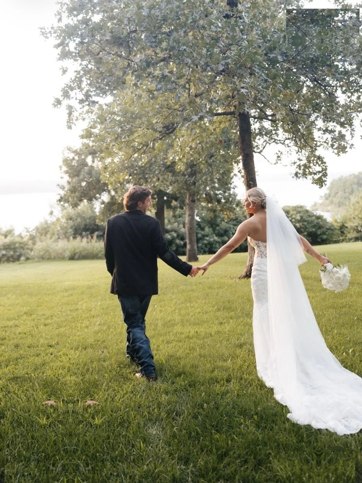  Bride and groom walking away hand in hand after their wedding at The Springs. 