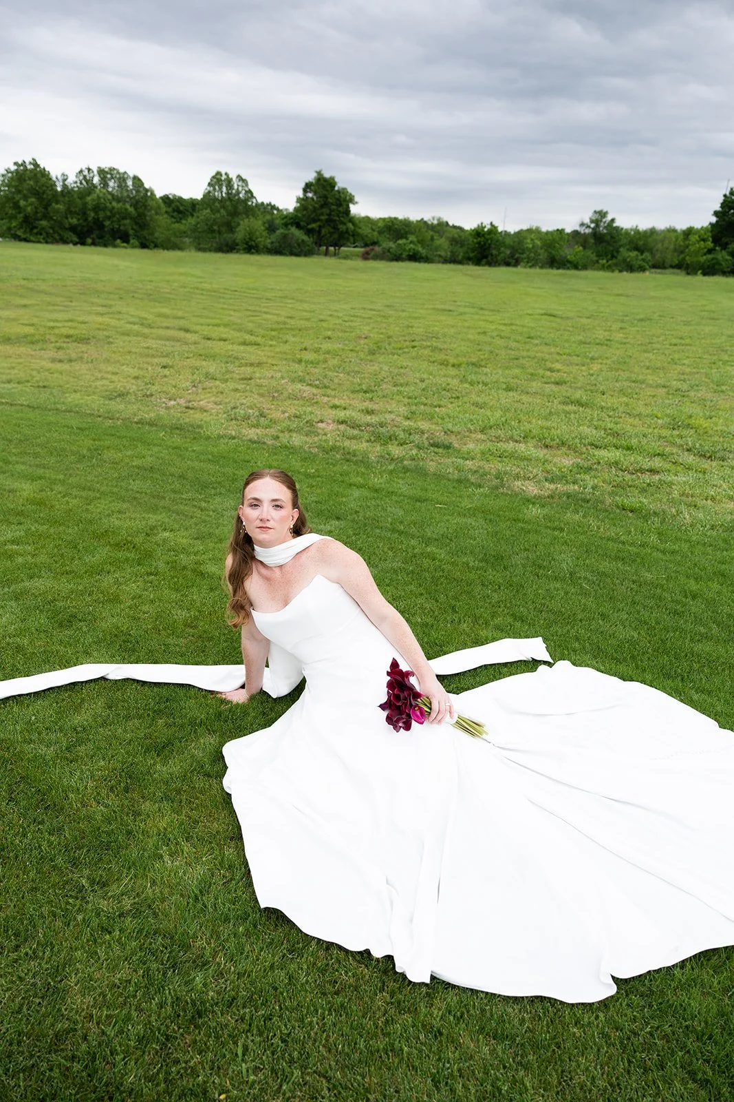 Elizabeth on the lawn, gown spread around her, under the big Oklahoma sky · source: Couple, couple_13
