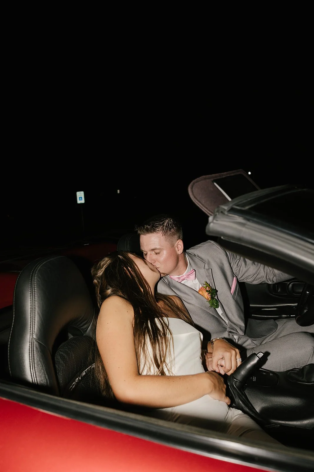couple kissing in convertible