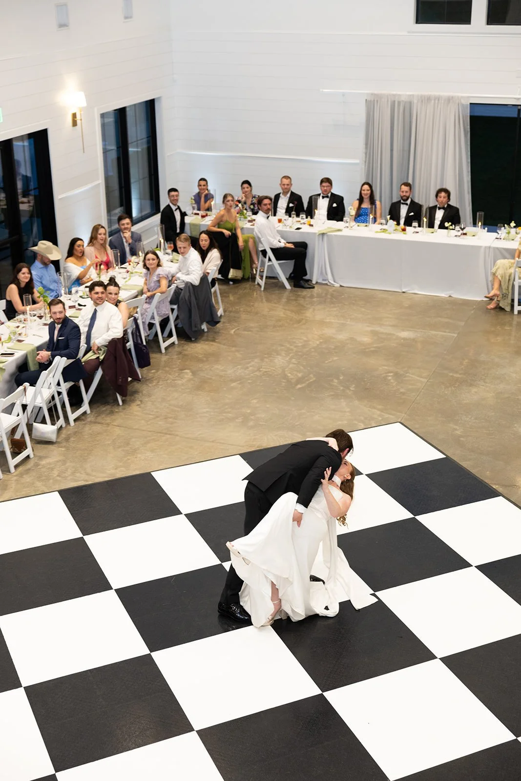first dance — the dip, on the black-and-white checkered floor · source: Reception, 