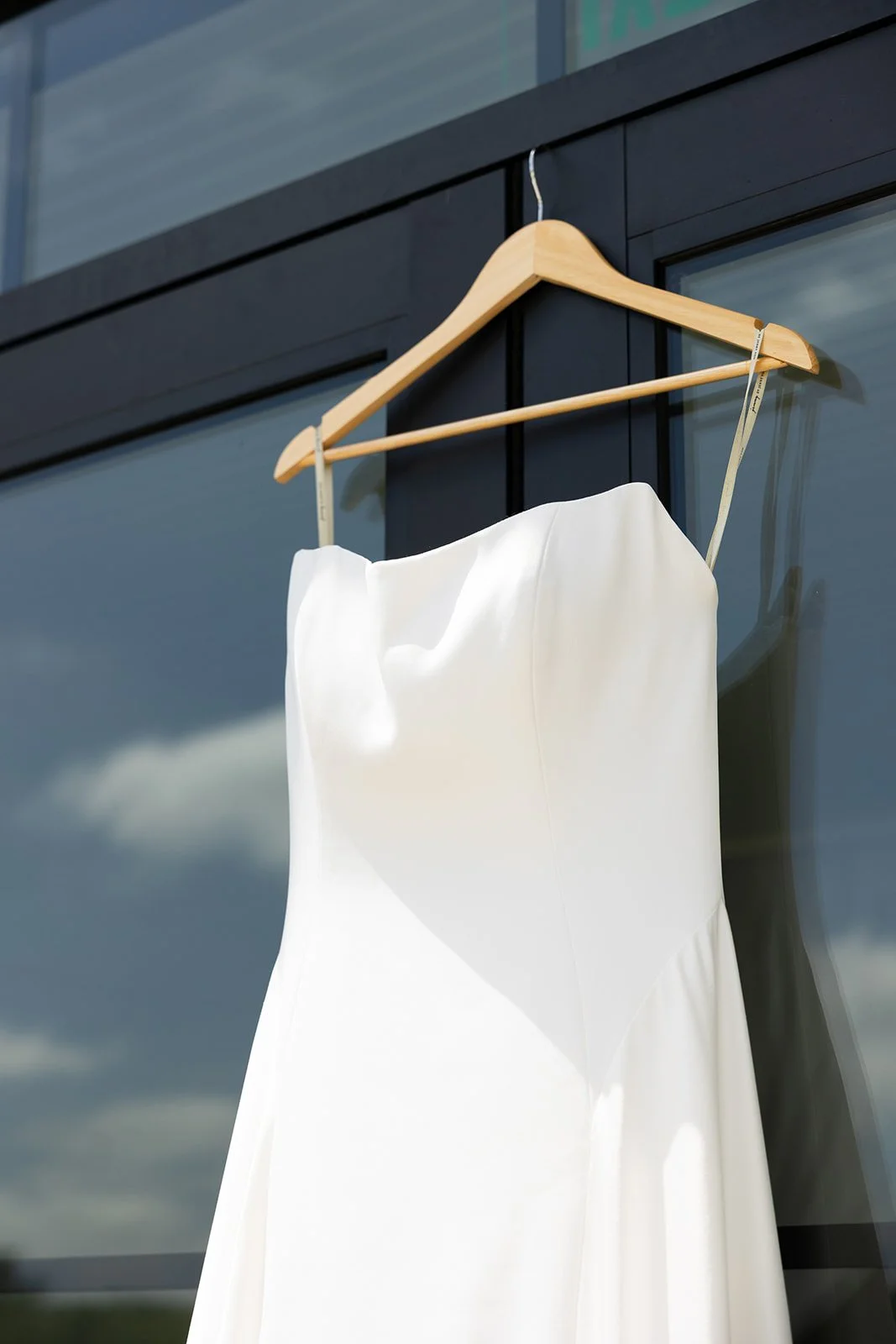 Elizabeth's gown hanging against the manor windows · source: Details + Getting Ready, details_02