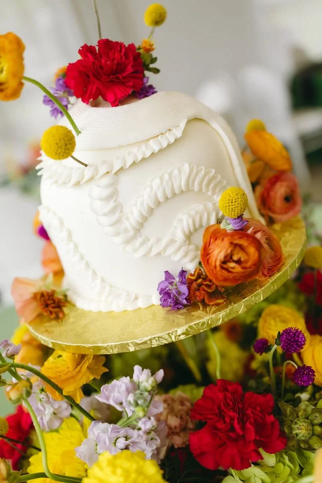 dome wedding cake with bright florals