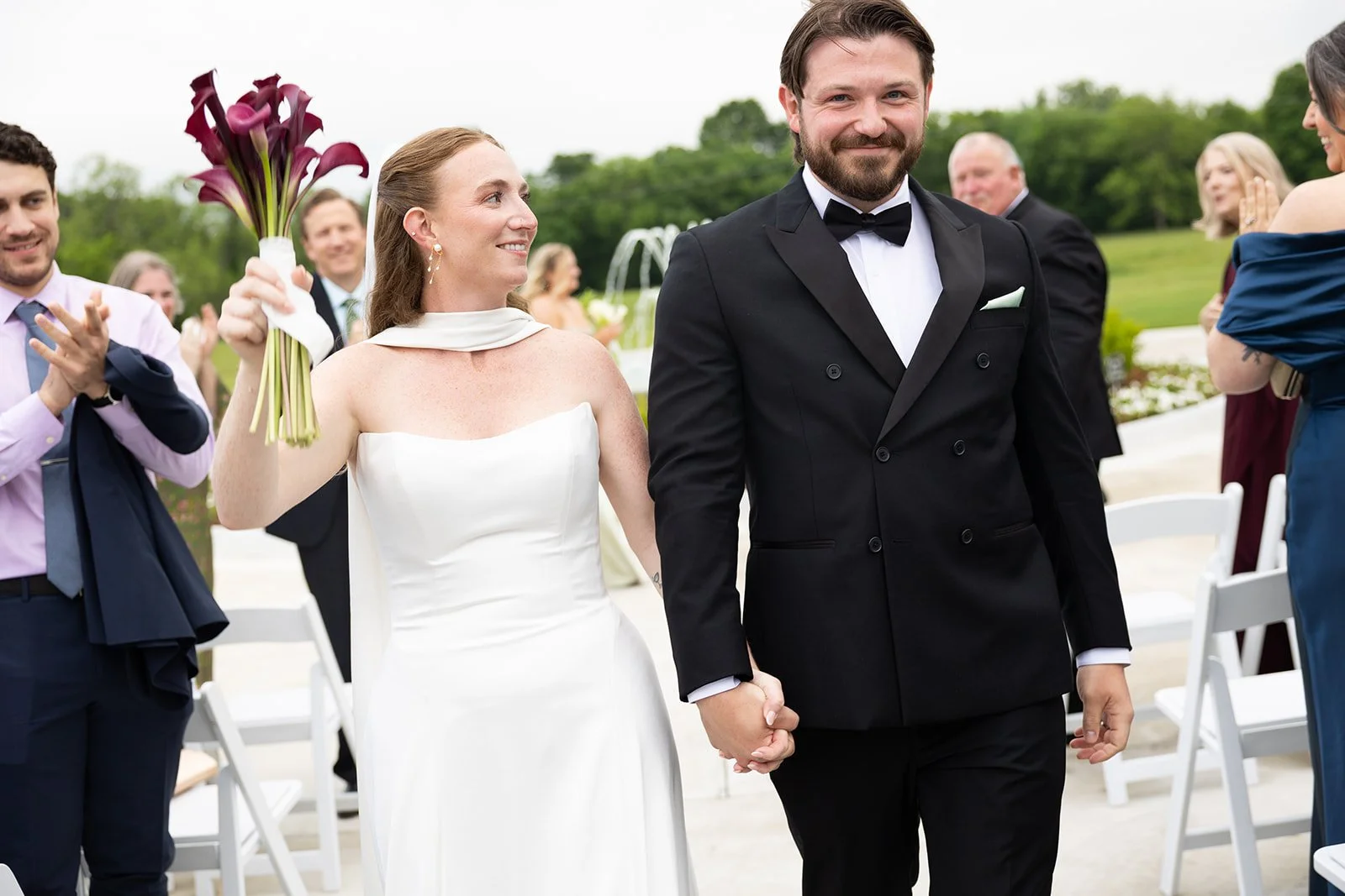 just married — walking back up the aisle, Elizabeth waving her bouquet · source: Ceremony, ceremony_22