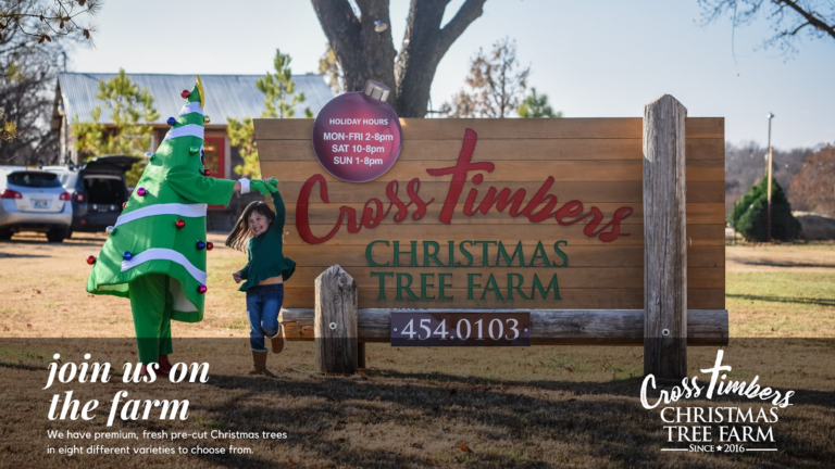 A person dressed as a Christmas tree with ornaments and a girl holding hands, standing near a sign for Cross Timbers Christmas Tree Farm, offering various holiday hours and contact information.