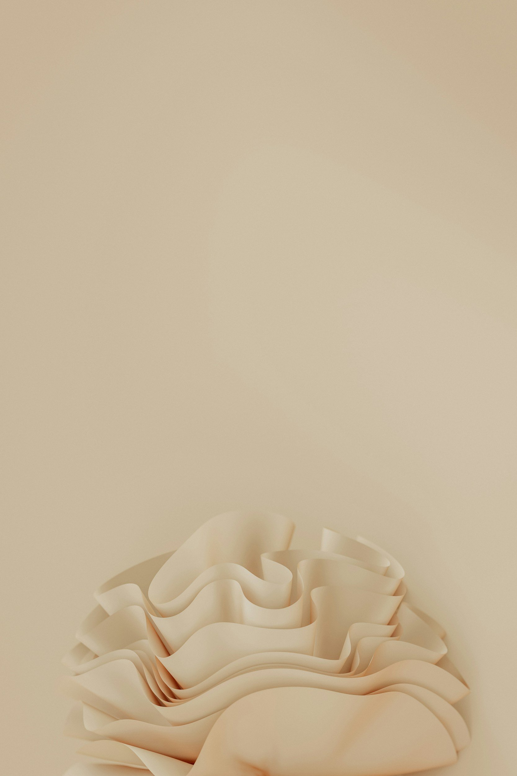Close-up of a beige wall with a decorative, layered paper sculpture at the bottom.
