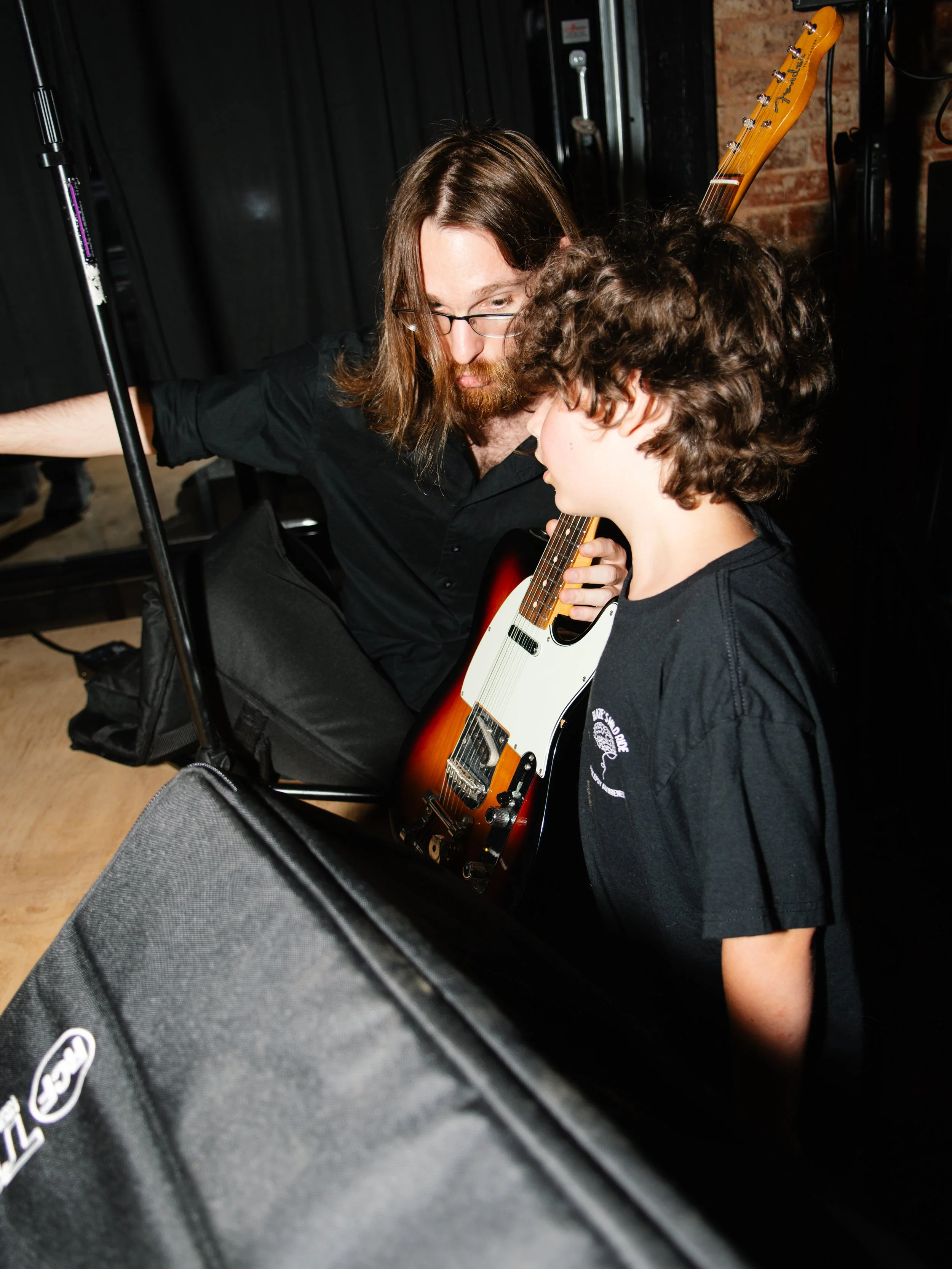 Band mate showing Blaze his guitar