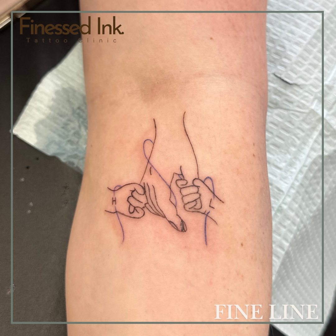 Fine line tattoo holding hands.png