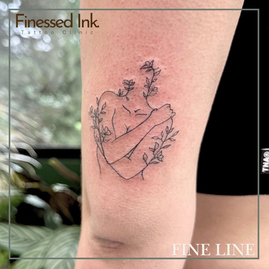 Fine line tattoo woman flowers.png
