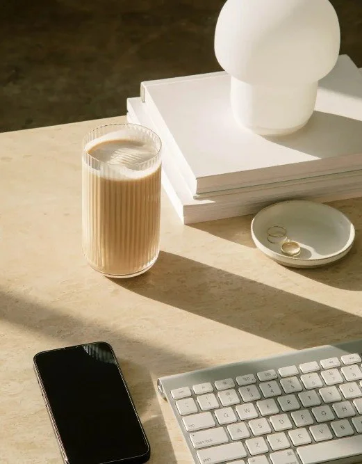 Modern and minimalistic workspace with a keyboard, mobile phone and coffee at Jiwaji Law