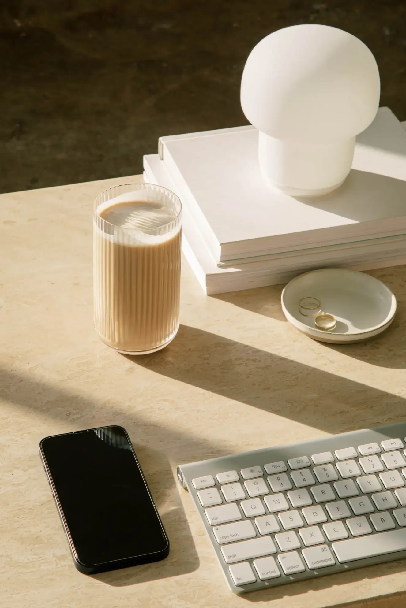 Modern and minimalistic workspace with a keyboard, mobile phone and coffee at Jiwaji Law