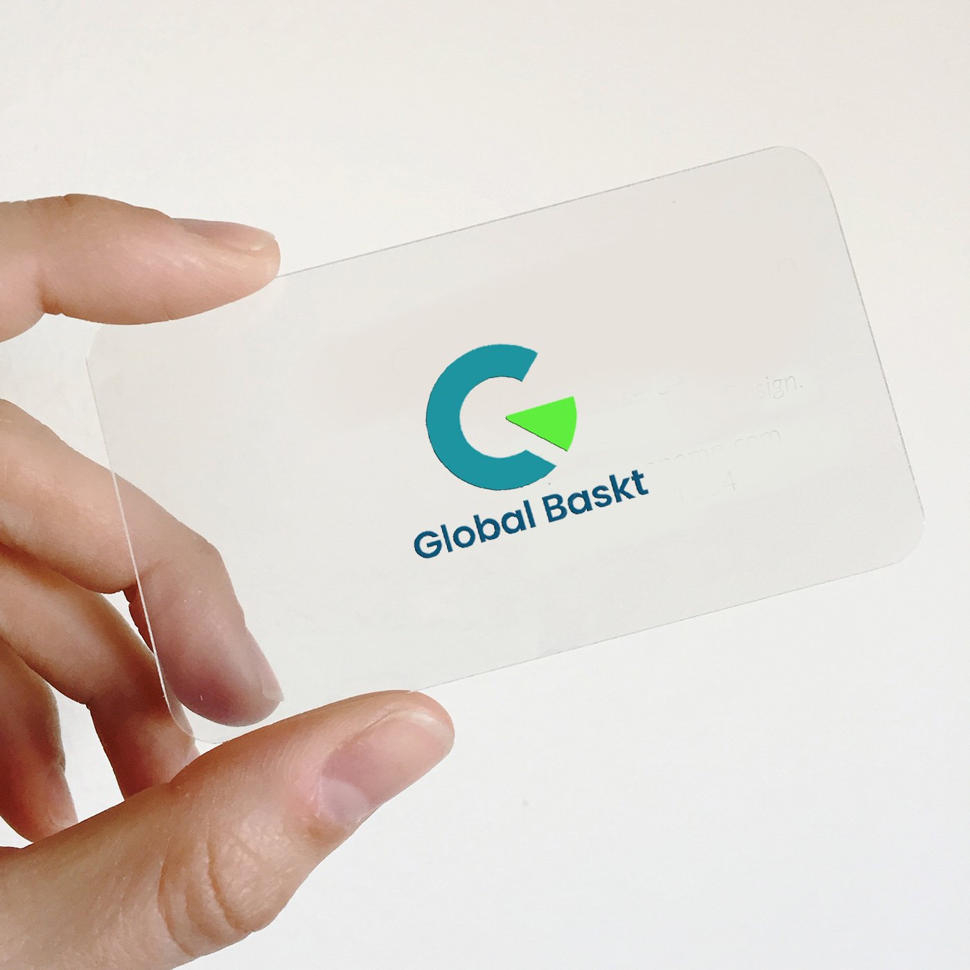 A clear plastic card with the GlobalBakst logo, featuring a stylized 'G' and a green arrow, held between a person's fingers.