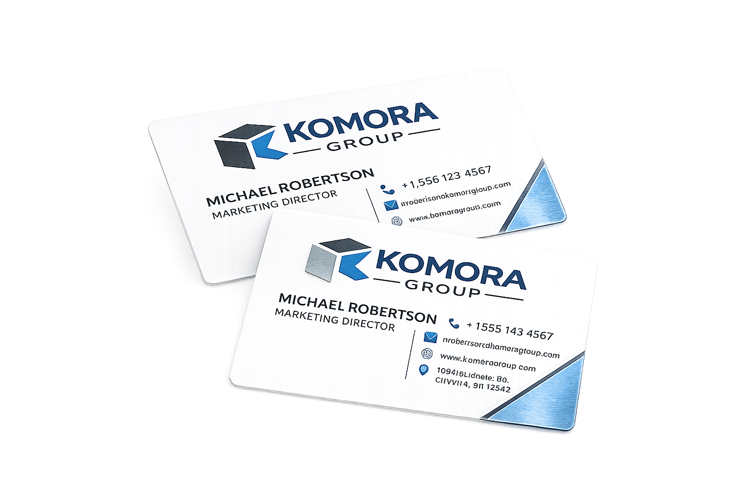 Two white business cards with blue and black design elements, featuring the logo and contact information for Komora Group, placed on a dark surface.