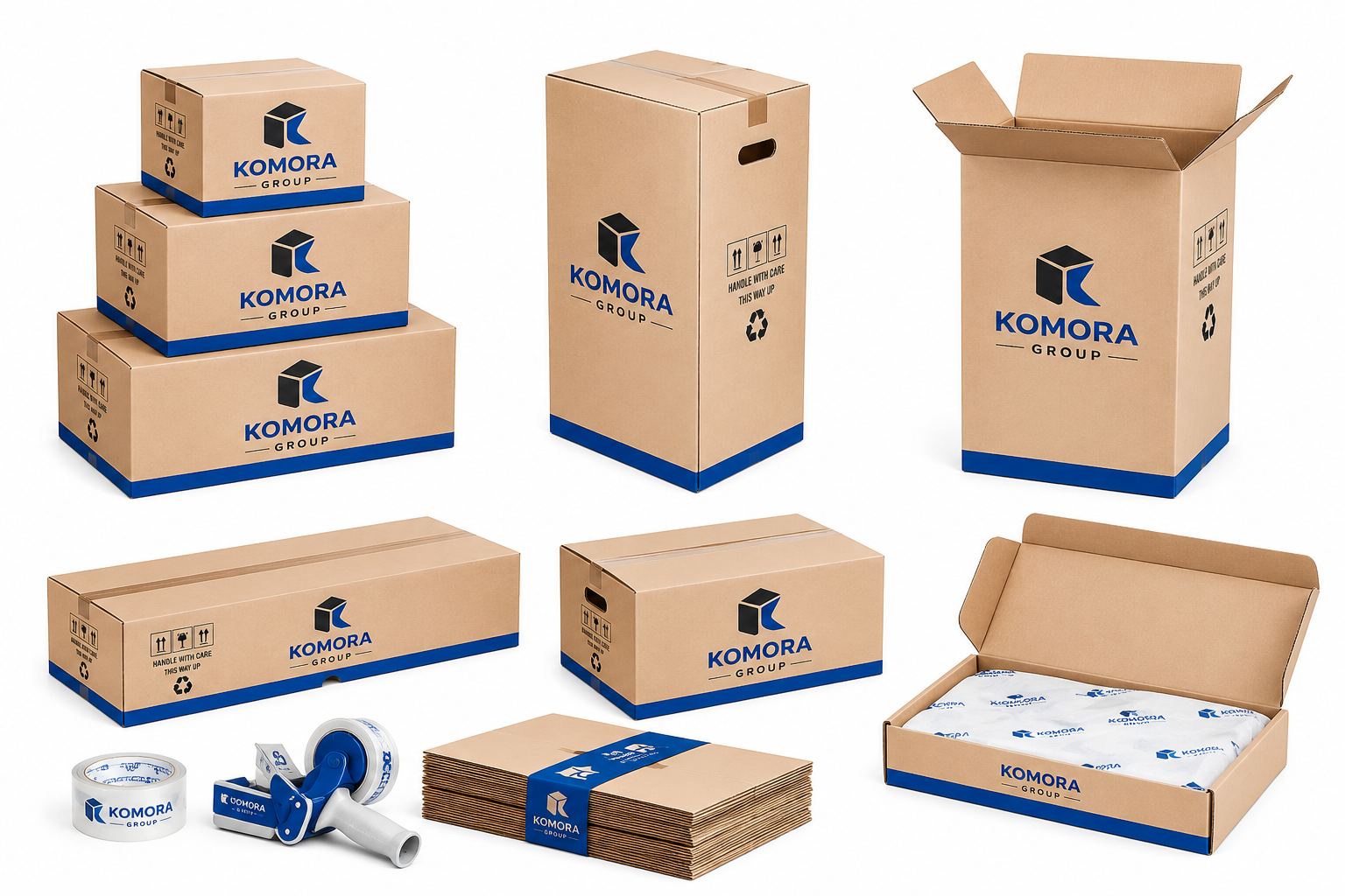 A collection of cardboard packing boxes, some stacked and some open, branded with 'Komora Group' logo. Includes packing tape, a roll of branded tape, a tape dispenser, a stack of paper, and an open box with branded packing paper inside.