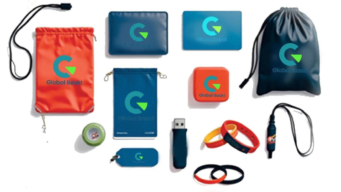 Collection of small gear, organizers, and accessories with 'Global Basket' logos, including pouches, a drawstring bag, a USB drive, wristbands, a keychain, and a small container.