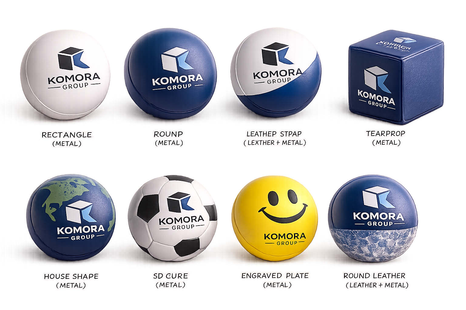 Collection of various promotional balls for Komora Group, including different shapes and styles such as rectangle, round, leather strap, tearprop, house shape, SD cure, engraved plate, and round leather, with logos and designs like a globe, soccer ball, and smiley face.