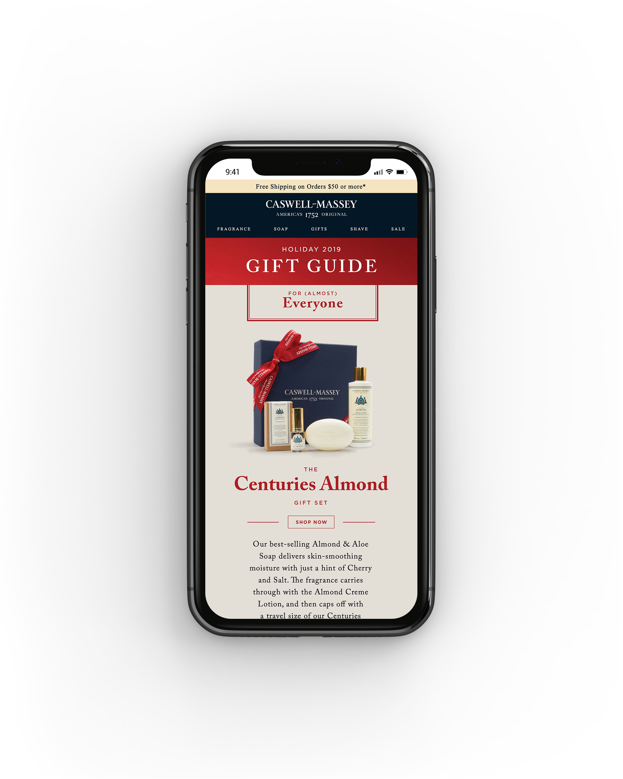 Mobile phone screen displaying a holiday gift guide for Centuries Almond soap by Caswell-Massey with a navy box tied with a red ribbon and soap bottles.